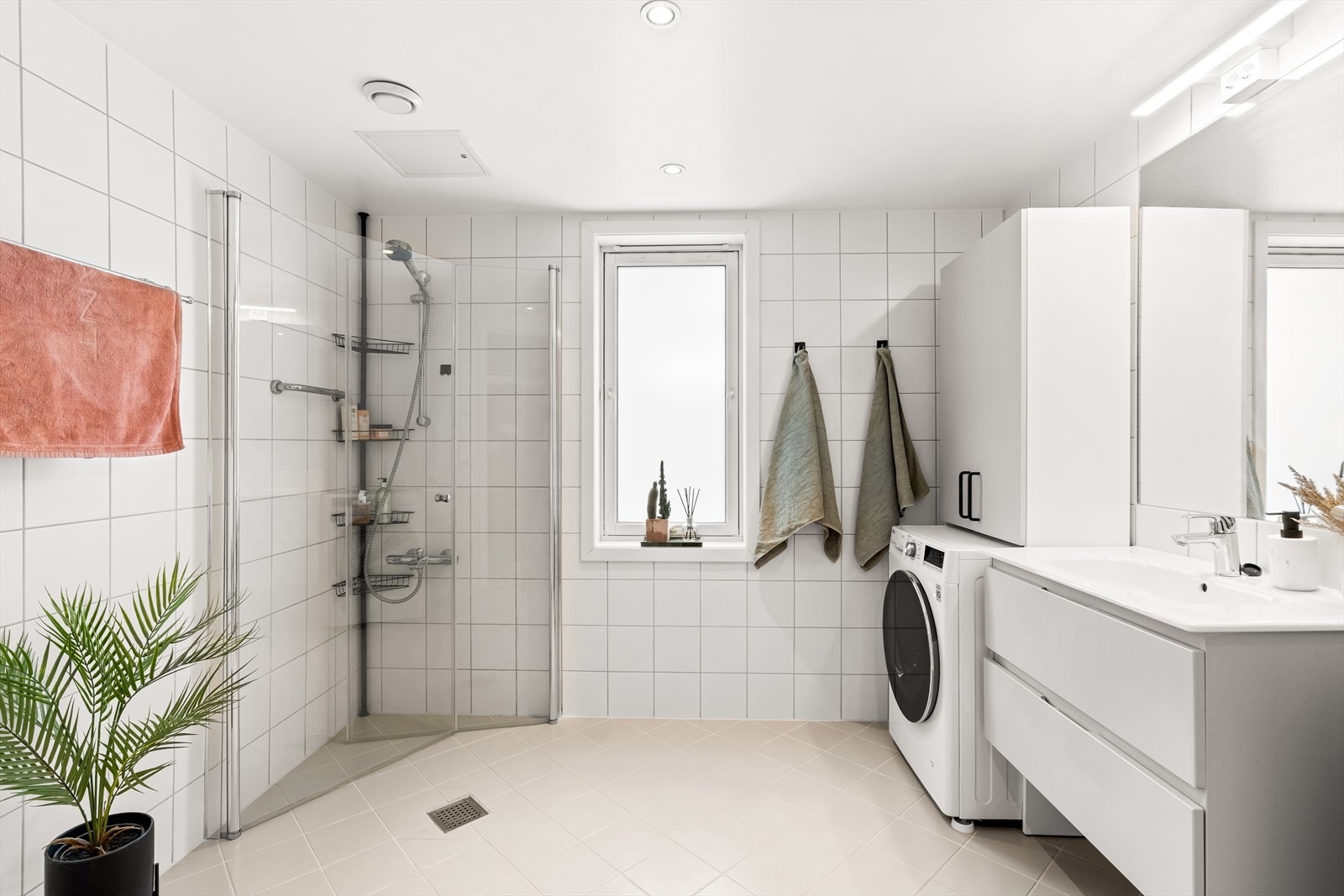 Baderommet fremstår som lyst og delikat, med praktiske løsninger og god planløsning. Rommet er utstyrt med dusjløsning, servant med underskap, toalett og tilrettelagt plass for vaskemaskin. Galleribilde