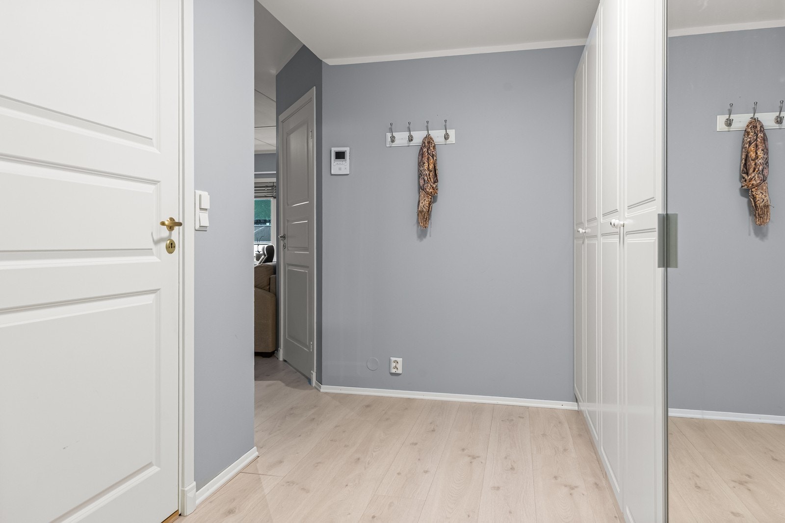 Leiligheten åpner seg opp med en praktisk gang med godt med garderobeskap, som gir rikelig plass til både yttertøy, sko og oppbevaring gjennom hele året. Galleribilde