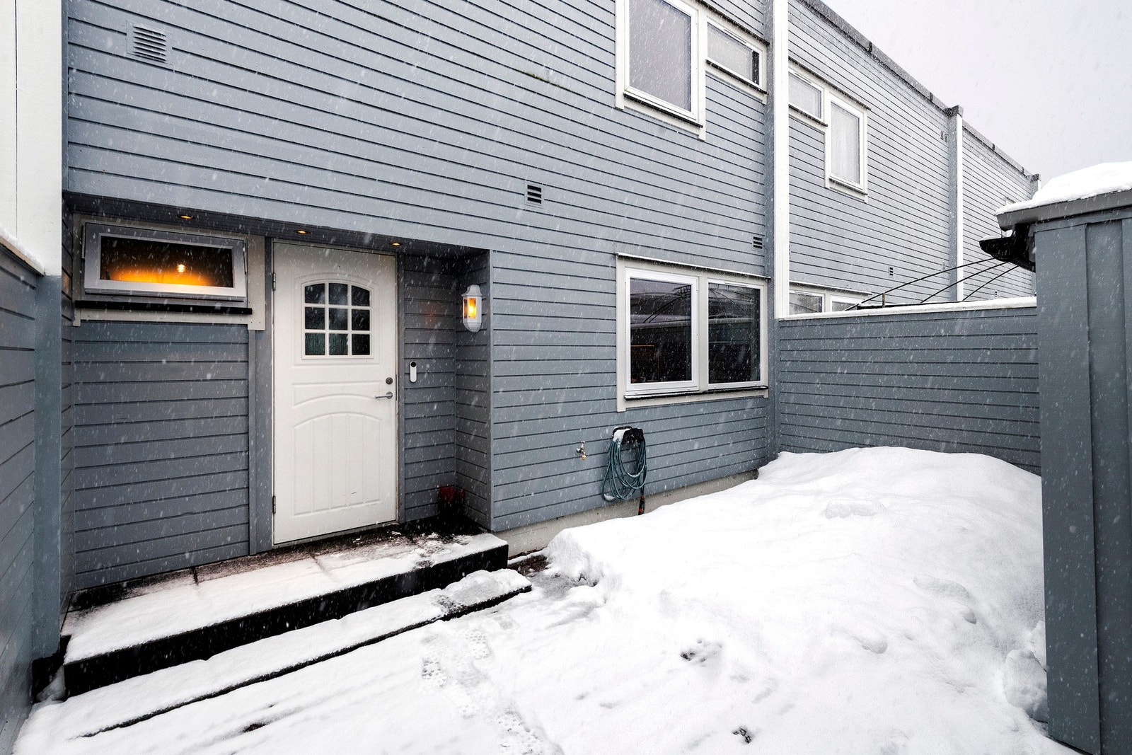 Inngangsparti med inngjerdet uteområde som gir en skjermet og privat adkomst til boligen Galleribilde