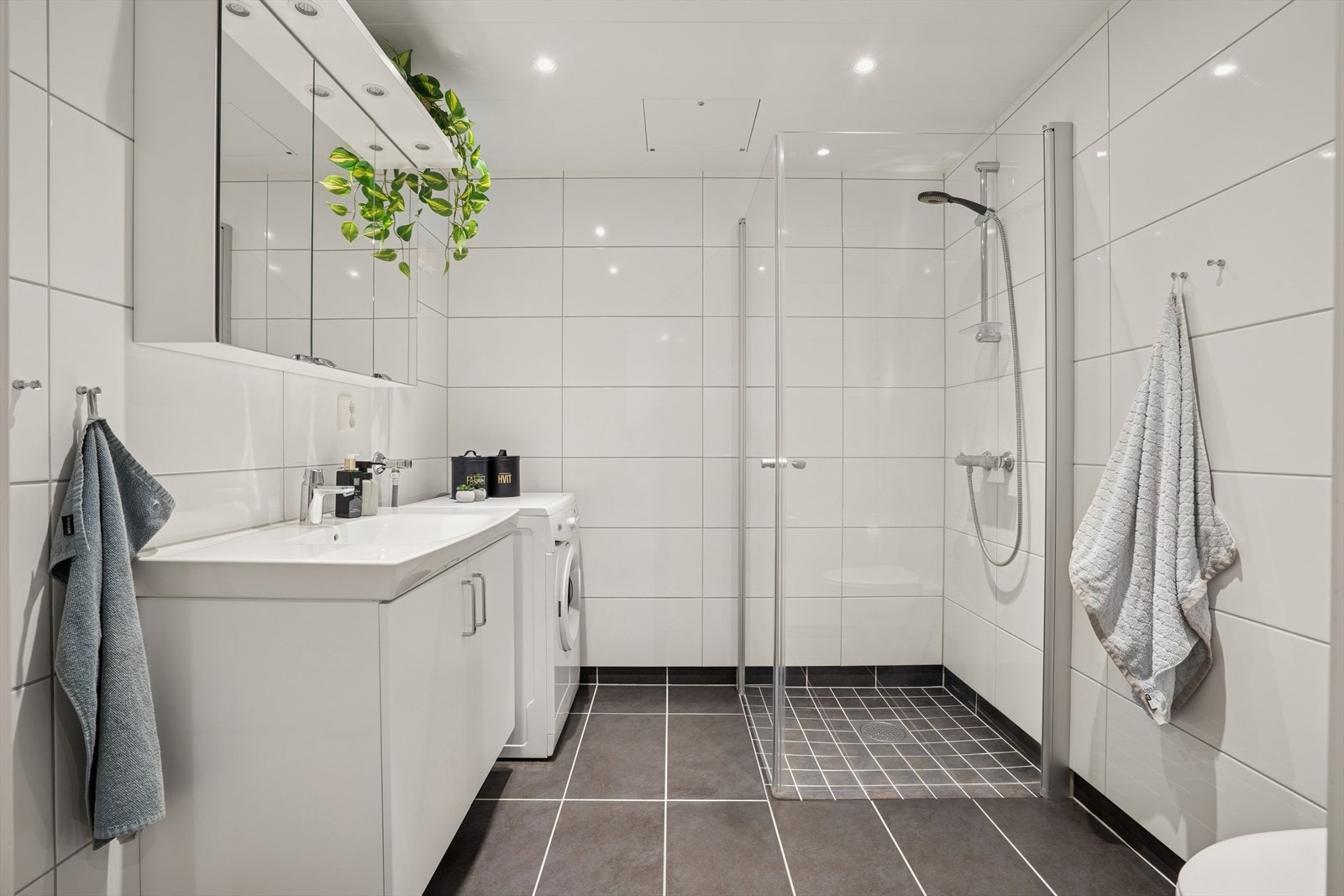 Flislagt baderom med varmekabler, opplegg til vaskemaskin og dusjhjørne Galleribilde