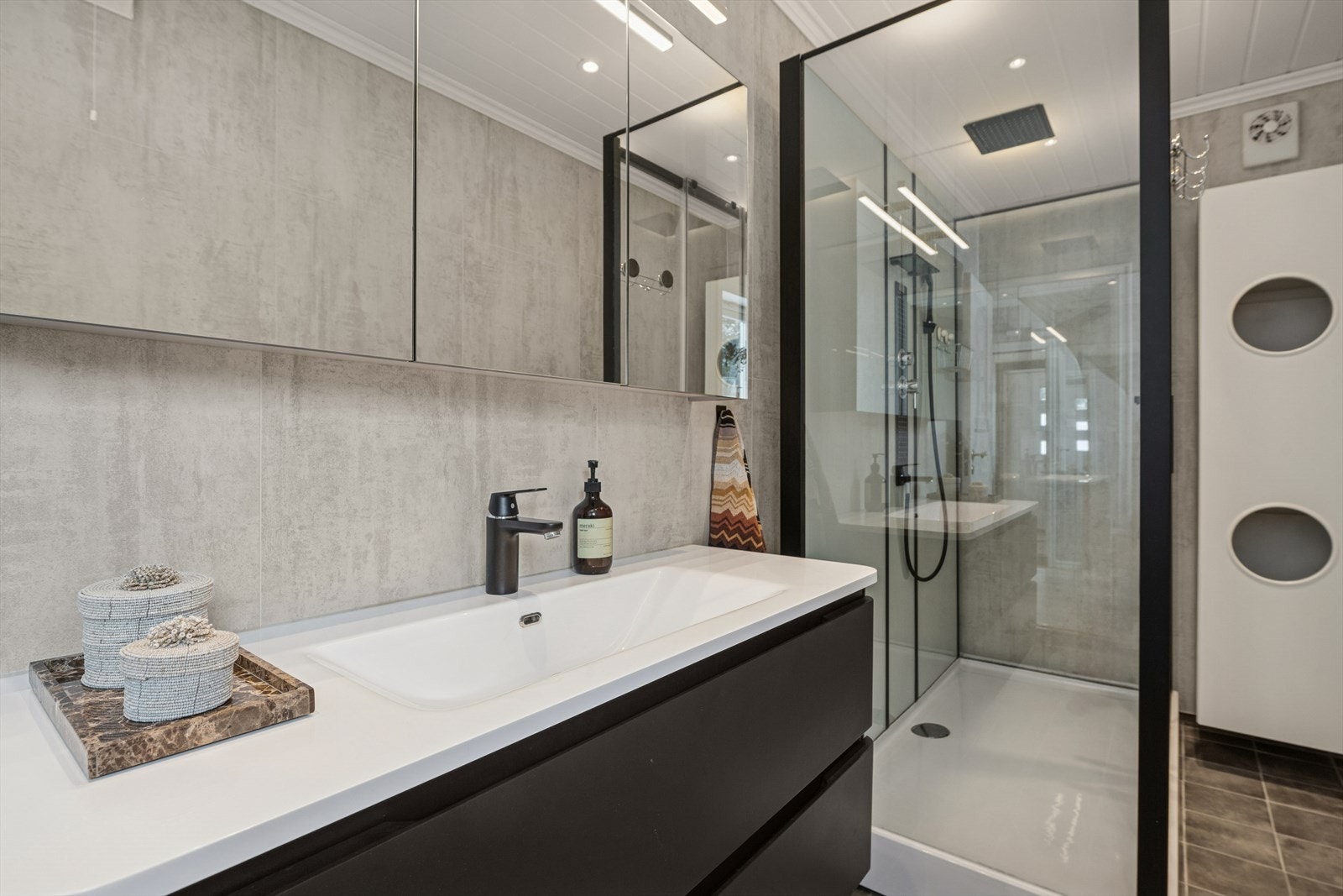 Badet ble oppusset i 2020 og fremstår som både funksjonelt og pent, med moderne innredning, baderomsplater og gulvvarme. Galleribilde