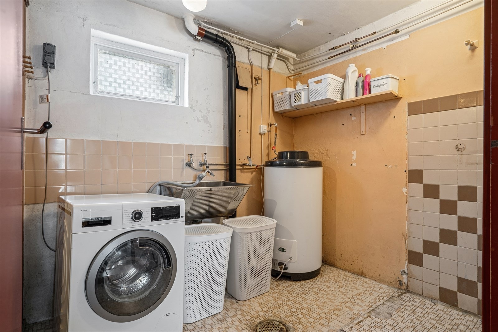 Vaskerommet i U. etasje er utstyrt med et rustfritt vaskekar, opplegg for vaskemaskin og en varmtvannsbereder på 190 liter fra 2020. Galleribilde