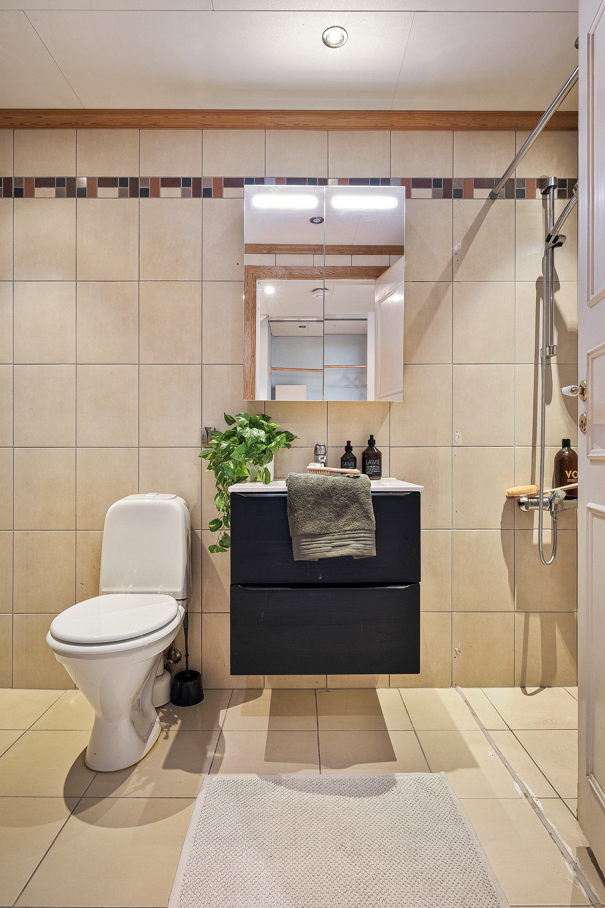 Badet på 5 kvm fremstår som moderne og funksjonelt med helflisede overflater. Her er det behagelige varmekabler i gulvet og innfelte downlights i taket som gir god belysning. Galleribilde