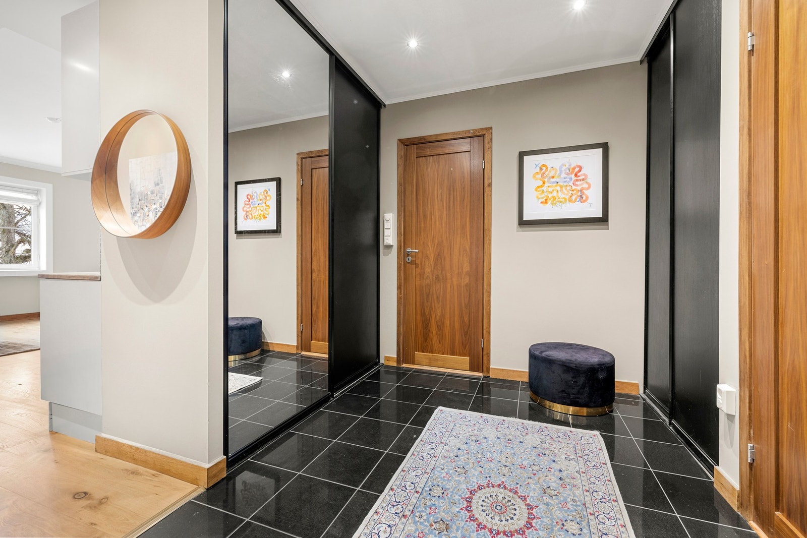 Romslig og innbydende entré med plass for klesoppheng og oppbevaring av sko i stor skyvedørsgarderobe. Galleribilde