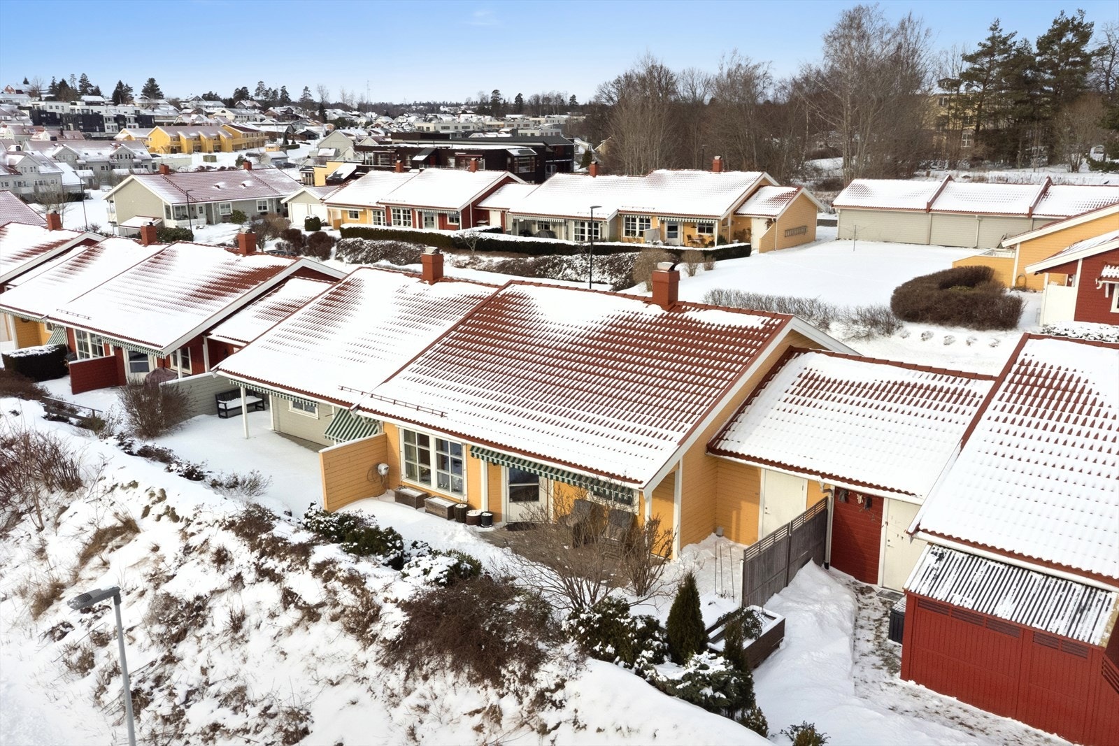 På sydsiden dekkes store deler av tomten som disponeres av den store treterrassen. Denne delen av fri for gressplen, men er ellers opparbeidet med noe beplantning som skaper en hyggelig atmosfære. Galleribilde