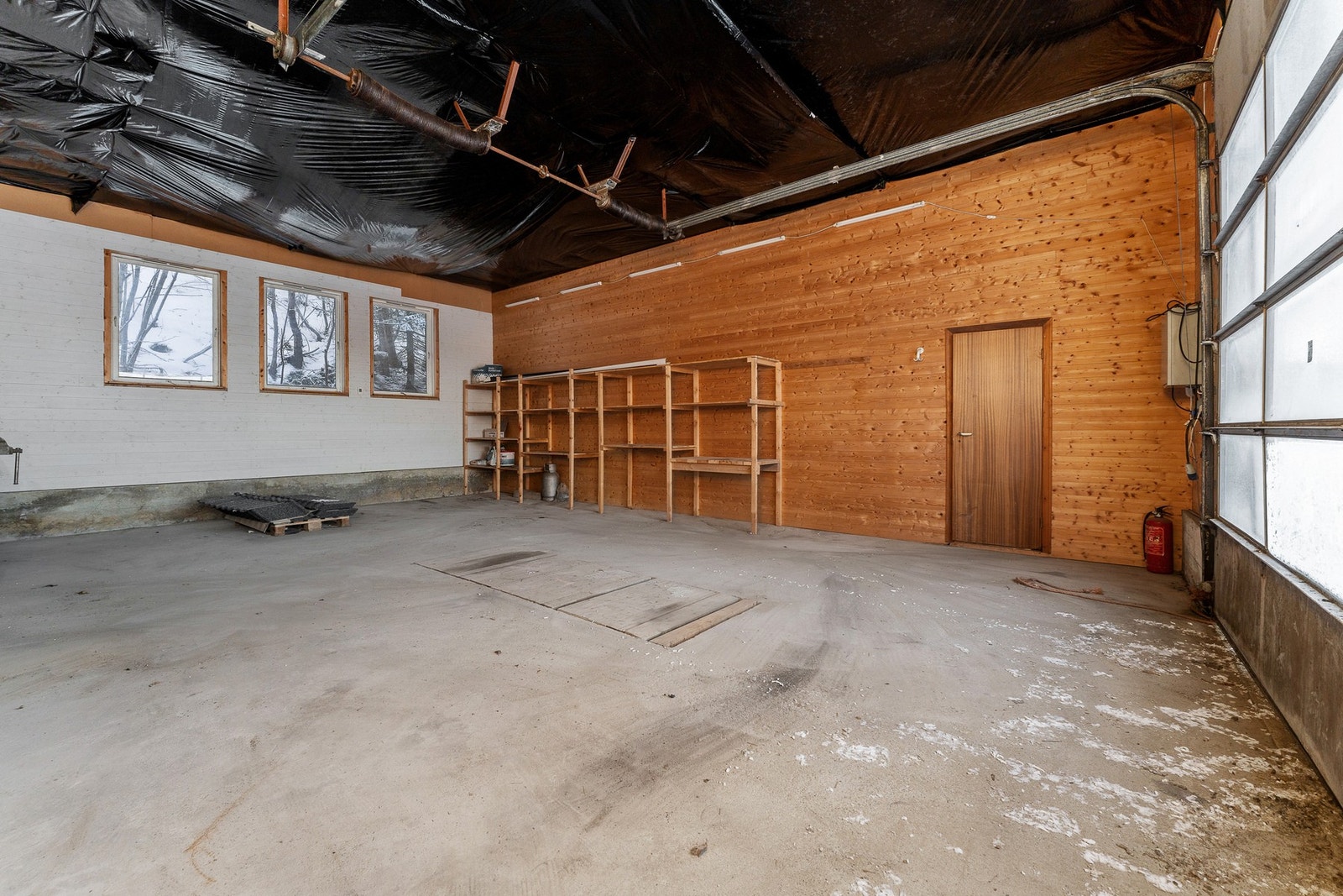 Denne delen er isolert. Ca 3-4m takhøyde. Innlagt strøm og 3-fas. Tidligere brukt til lakkering, derfor plast i taket. Galleribilde