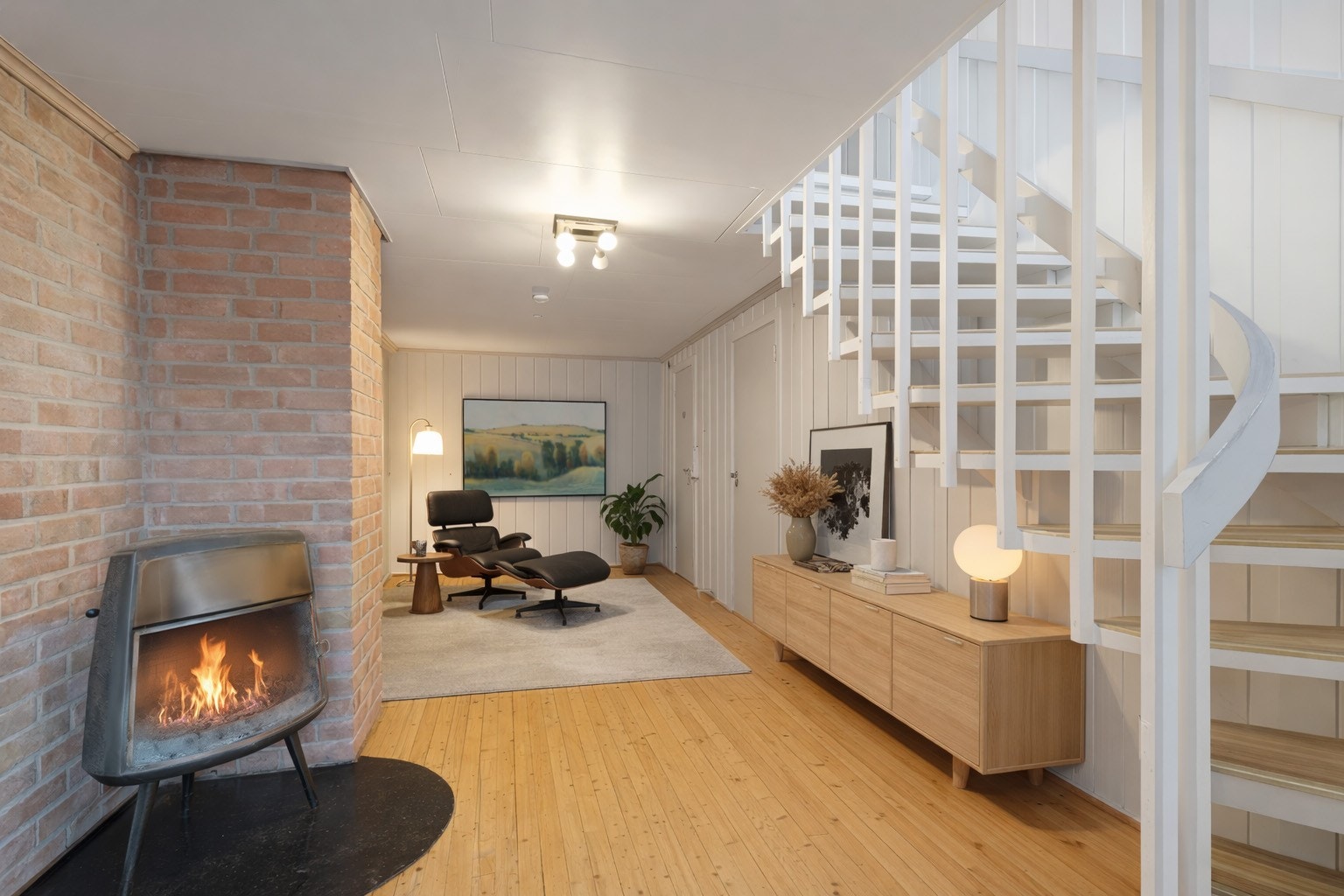 Underetasje - Entre og stue av åpen løsning med vedovn. Møbleringsforslag AI. Galleribilde