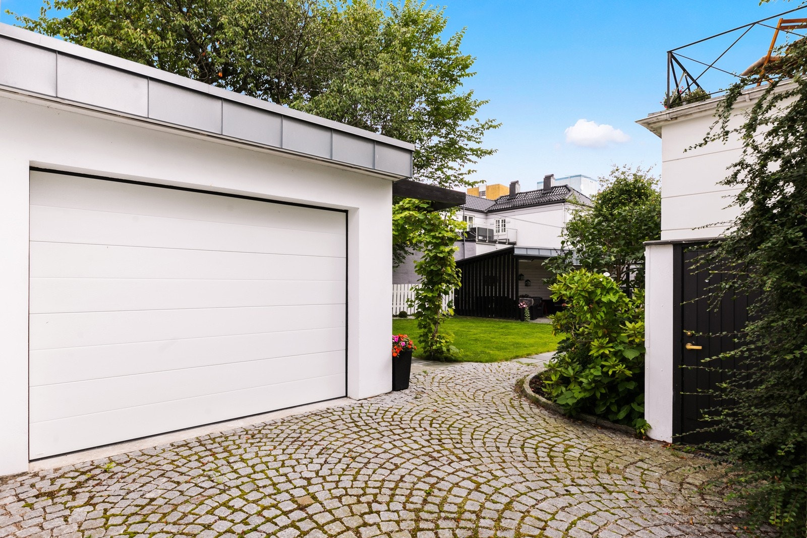 Ny garasje fra 2018 med brostein gårdsplass. Galleribilde