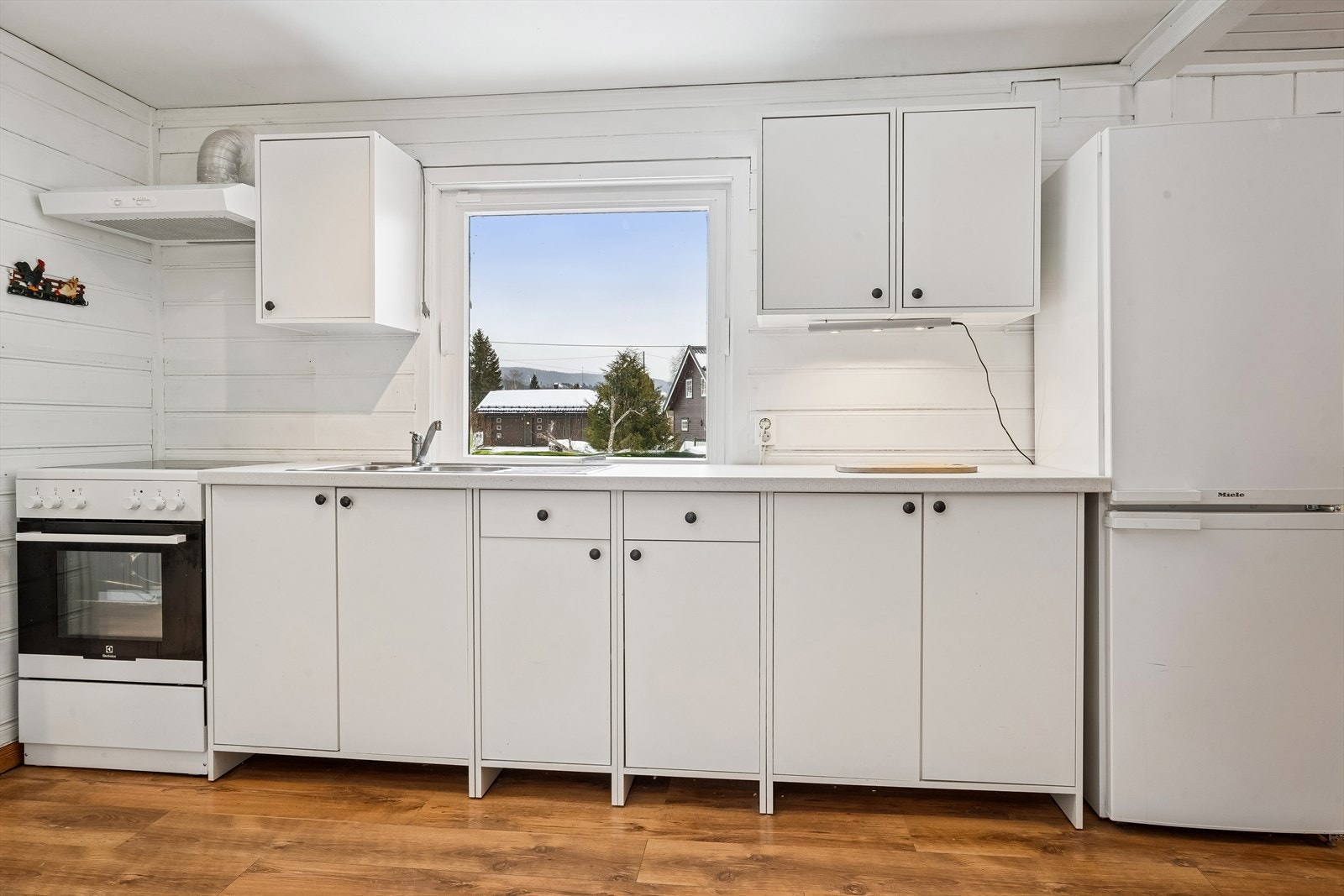 Det er frittstående komfyr og kjøleskap. Galleribilde