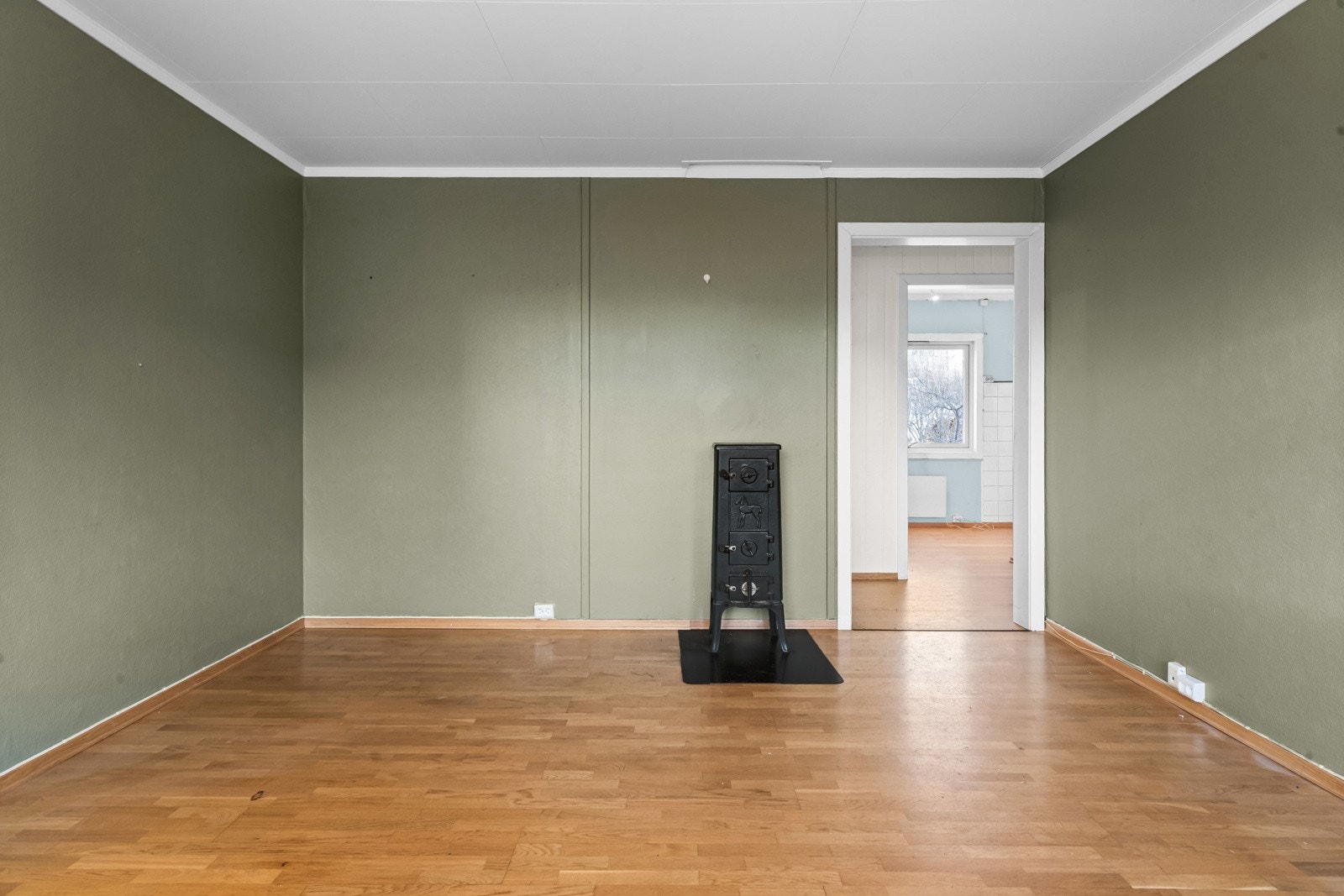 Det er montert vedovn i stuen, men tilstanden på denne er ikke kjent. Galleribilde