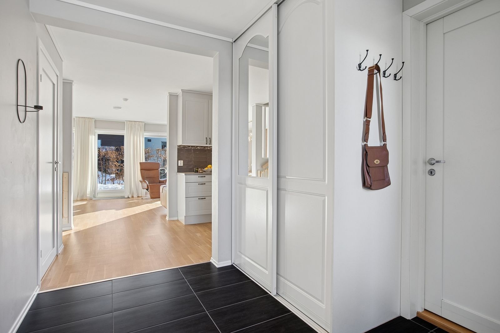 Innbydende entré med flislagt gulv og garderobe. Galleribilde