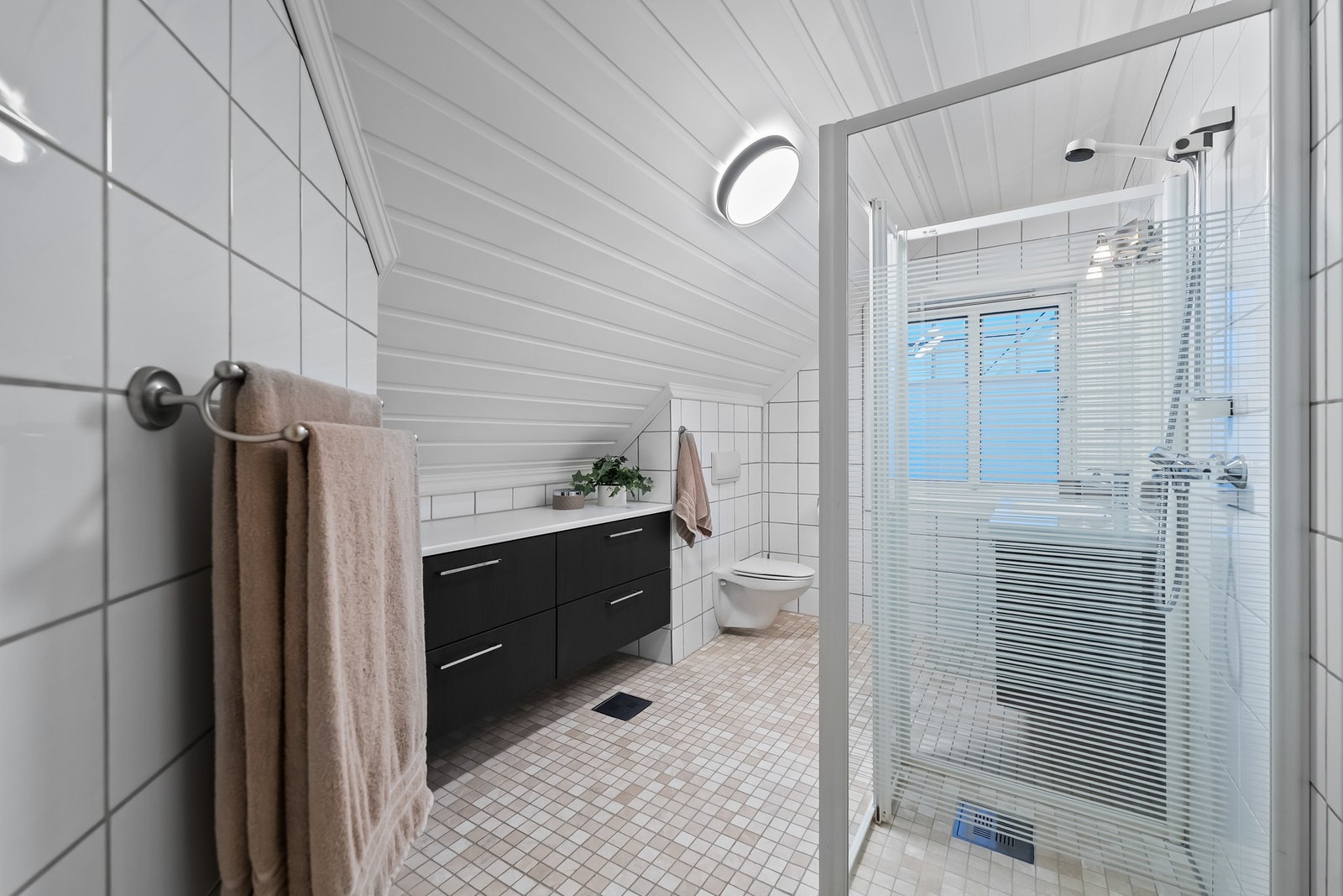 Heldekkende servantinnredning med skuffer. Flislagte overflater gir et tidløst og eksklusivt preg. Galleribilde