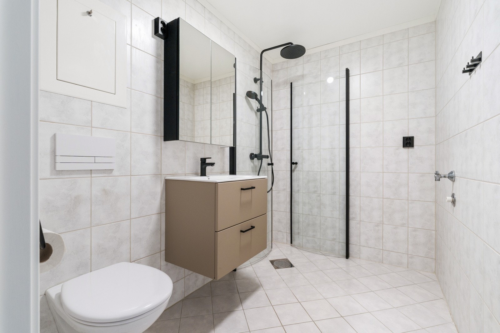 Baderommet er stilfult innredet med lyse fliser og moderne innredning. Galleribilde