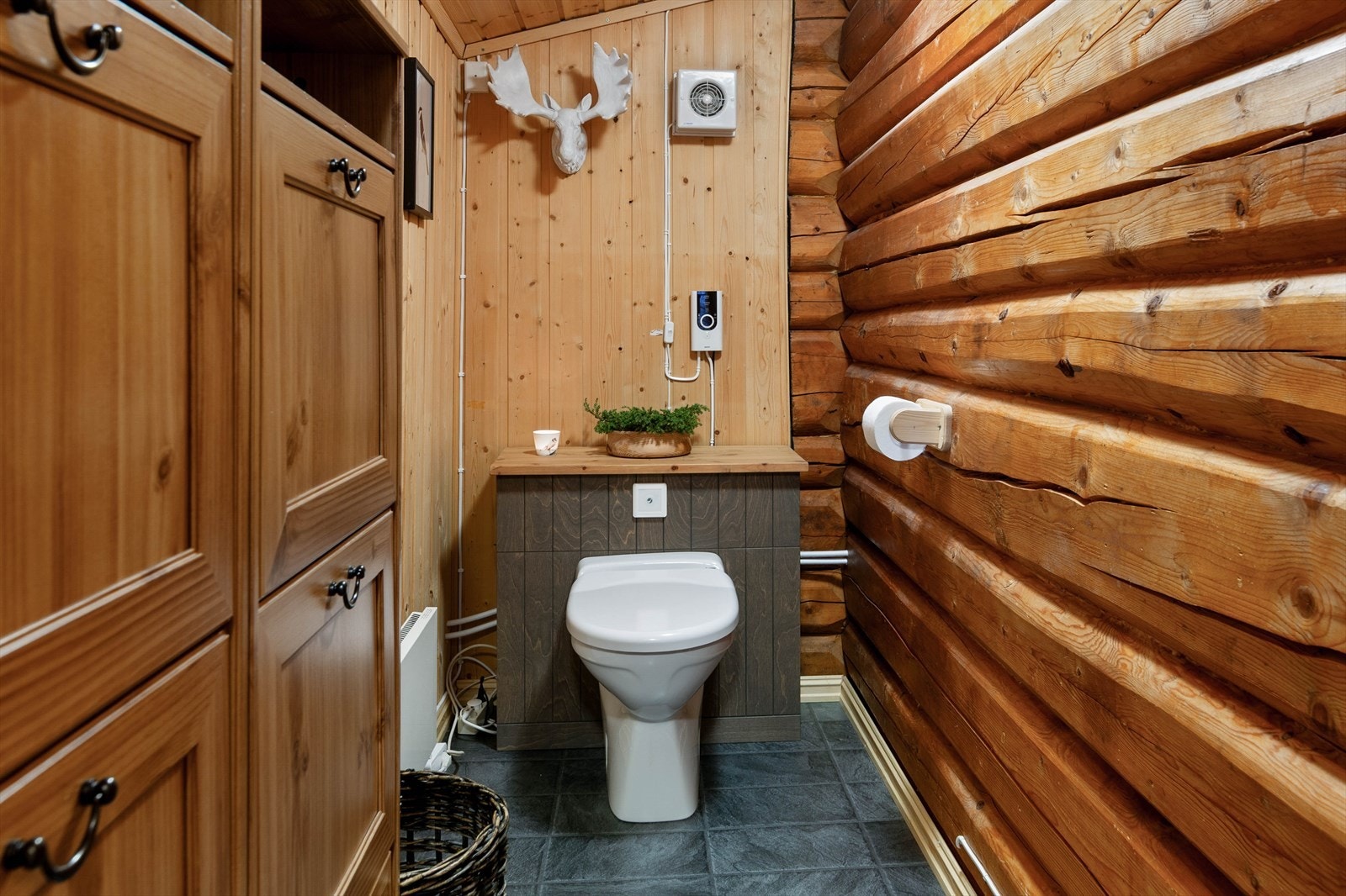 I hytta er det laget et fint toalettrom med vakkumklosett med kvern, hvor styringspanel m.m. er innebygd i kasse. Som på bad, er det her ventilvifte i yttervegg. Galleribilde