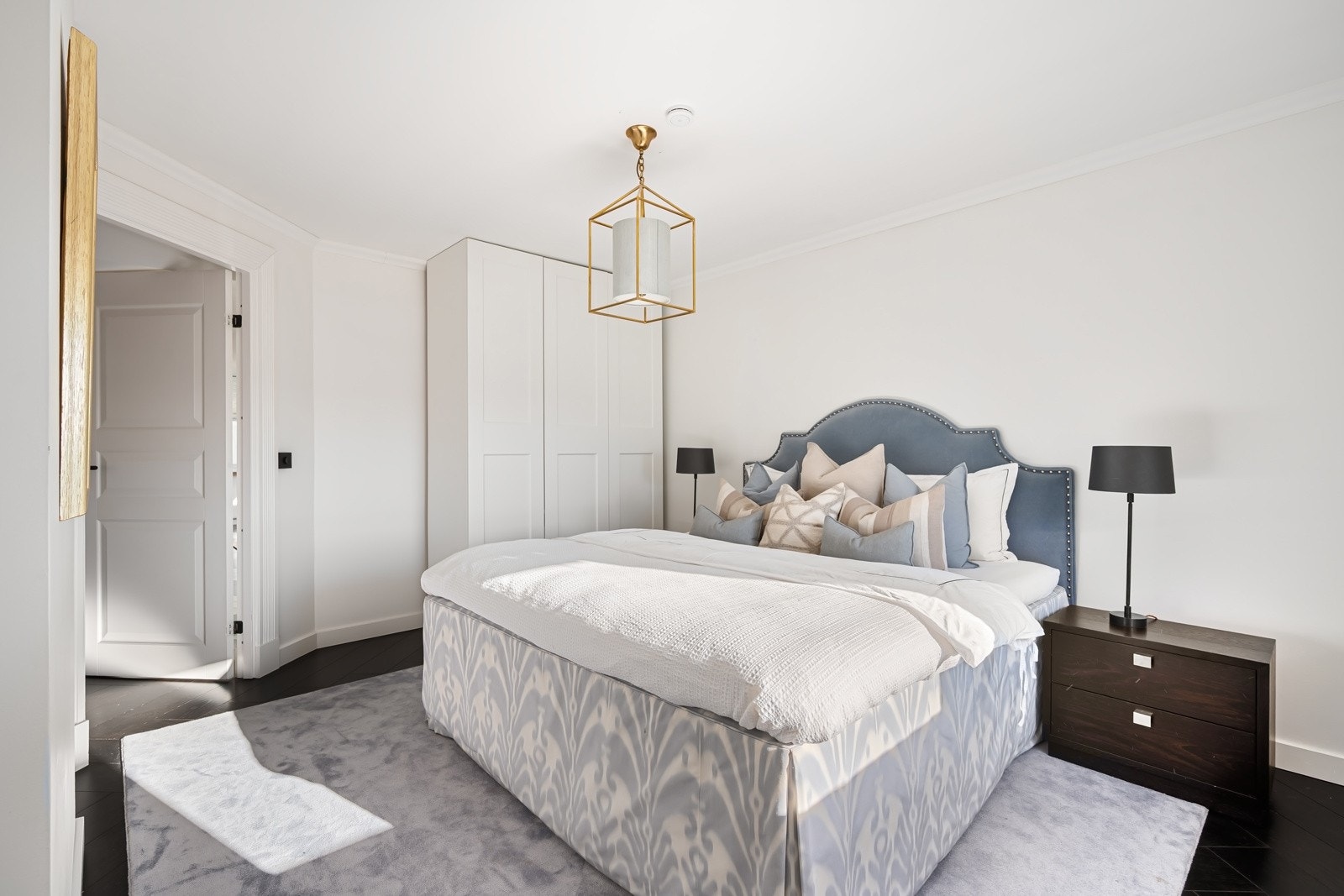 Gjestesuiten er innredet med takhøye, hvite garderobeskap. Galleribilde