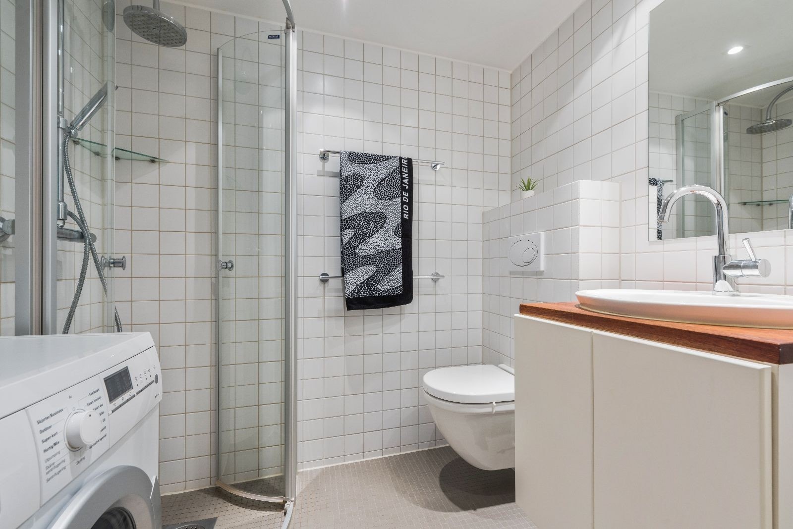 Bad med varmekabler, vaskemaskin og downlights i tak. Galleribilde