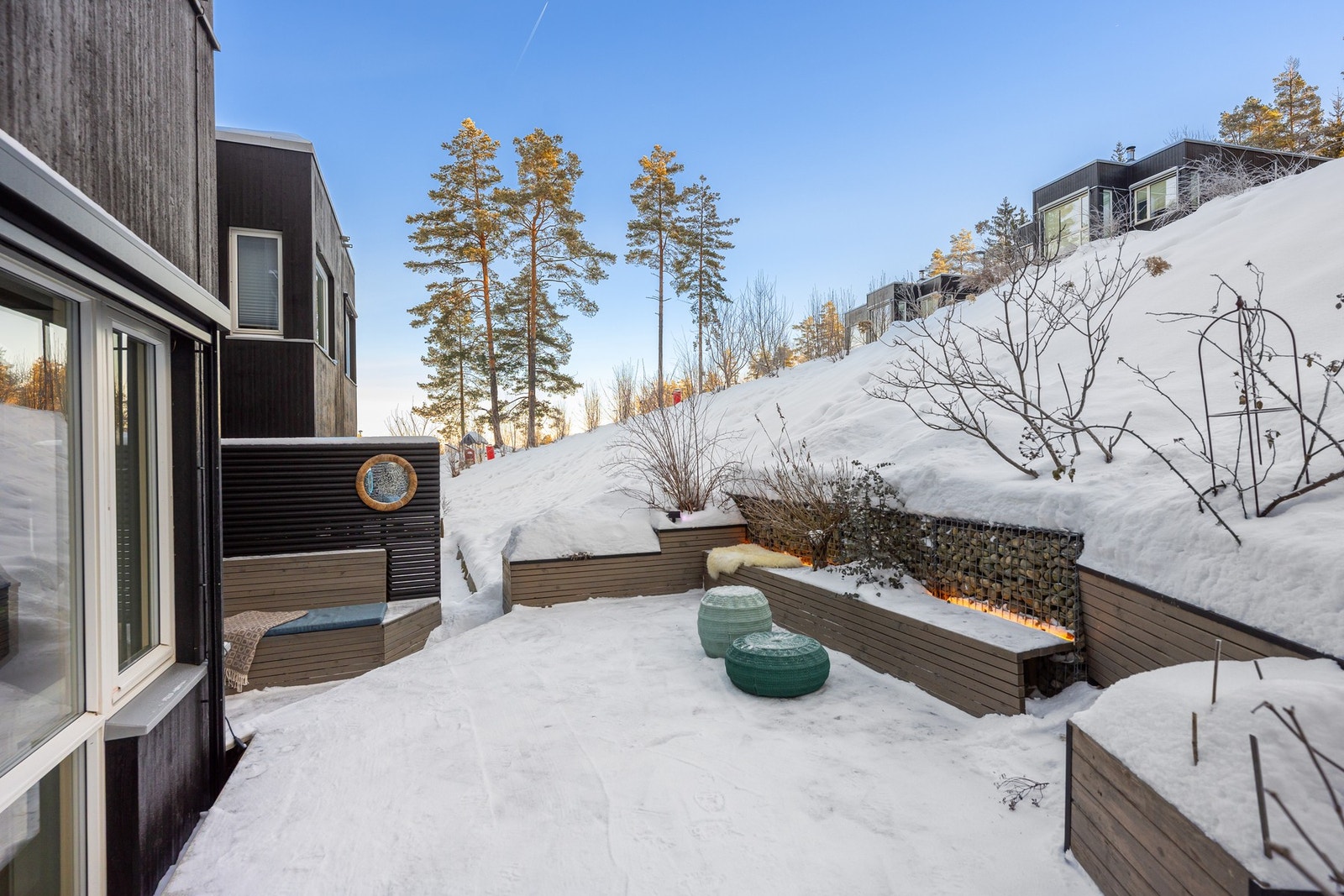 Her er det gjort et godt stykke arbeid med plassbygde benker med plantekasser og belysning. Galleribilde