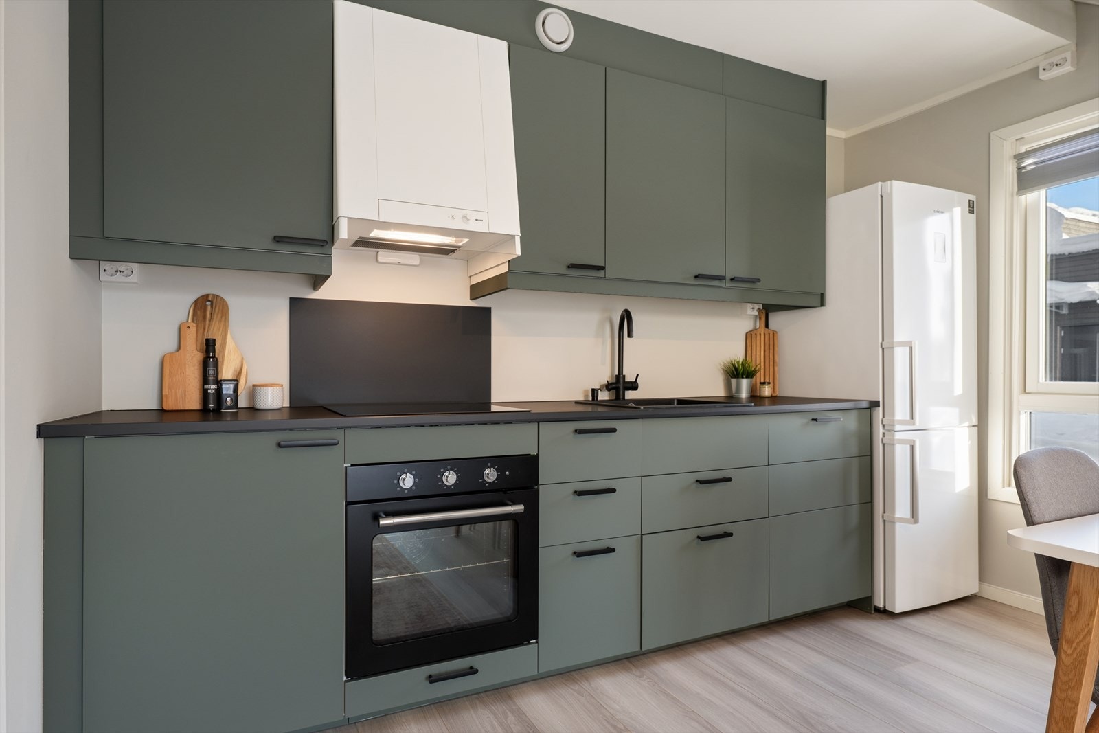 Kjøkkenet er innredet med grønne fronter som gir rommet et moderne og friskt uttrykk. Galleribilde