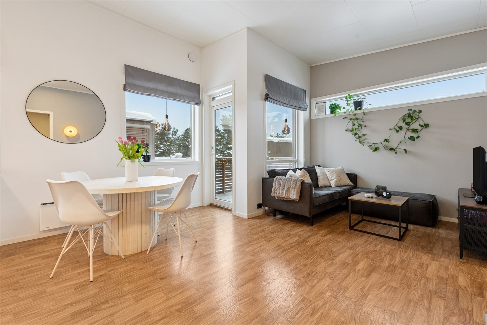 Leiligheten har en åpen stue- og kjøkkenløsning som skaper romslige og luftige arealer, med god plass til både en komfortabel sofagruppe og et stort spisebord, perfekt for både hverdagsliv og hyggelige sammenkomster. Galleribilde