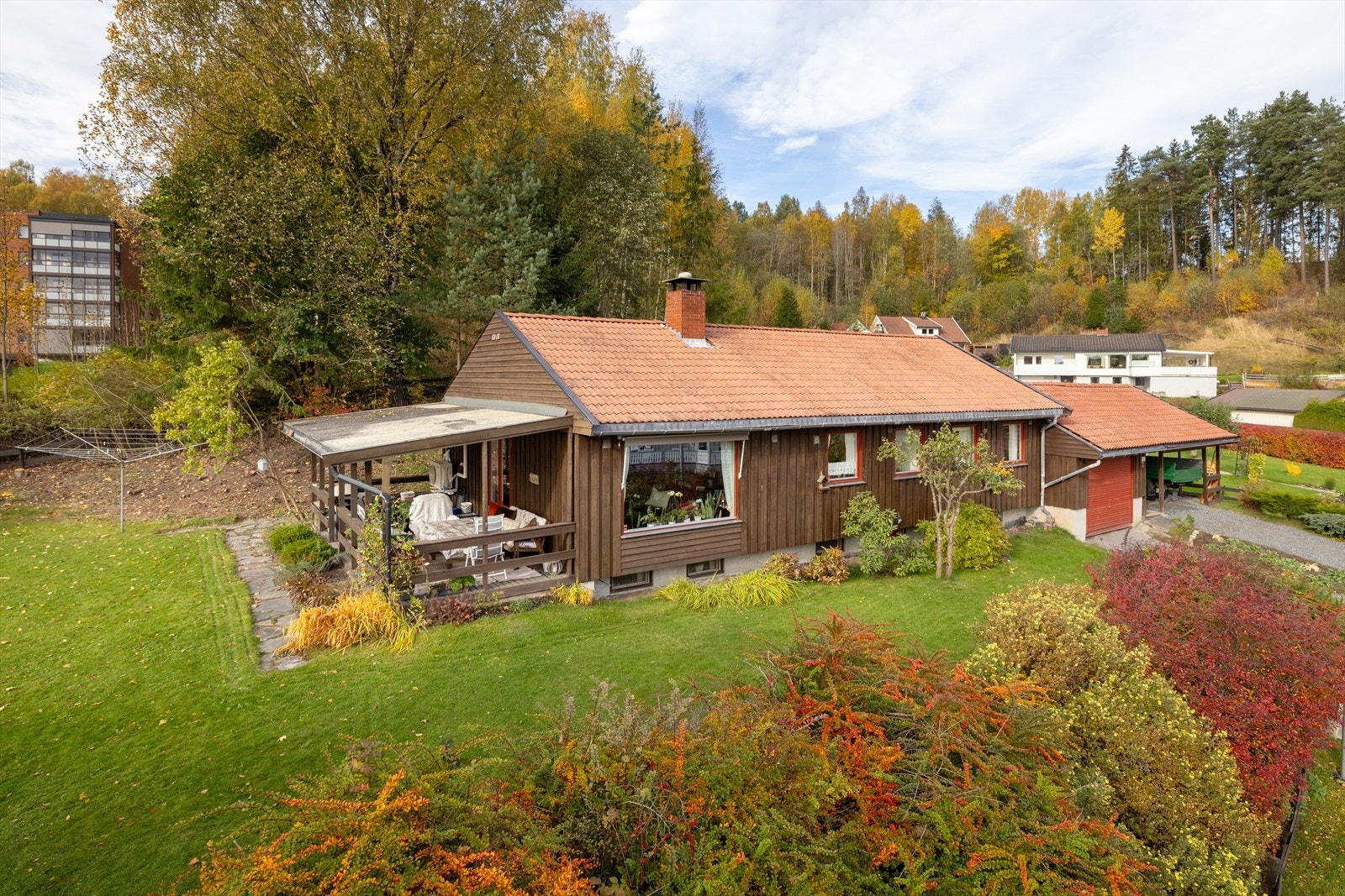 Boligen har en skjermet plassering i et etablert boligområde, med skogkanten som nærmeste nabo. Galleribilde