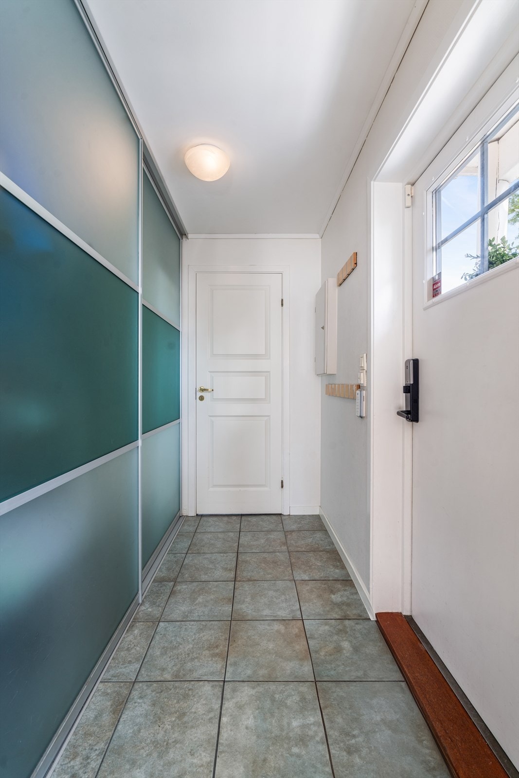 Inngangsparti / entrè med stor skyvedørsgarderobe. Galleribilde