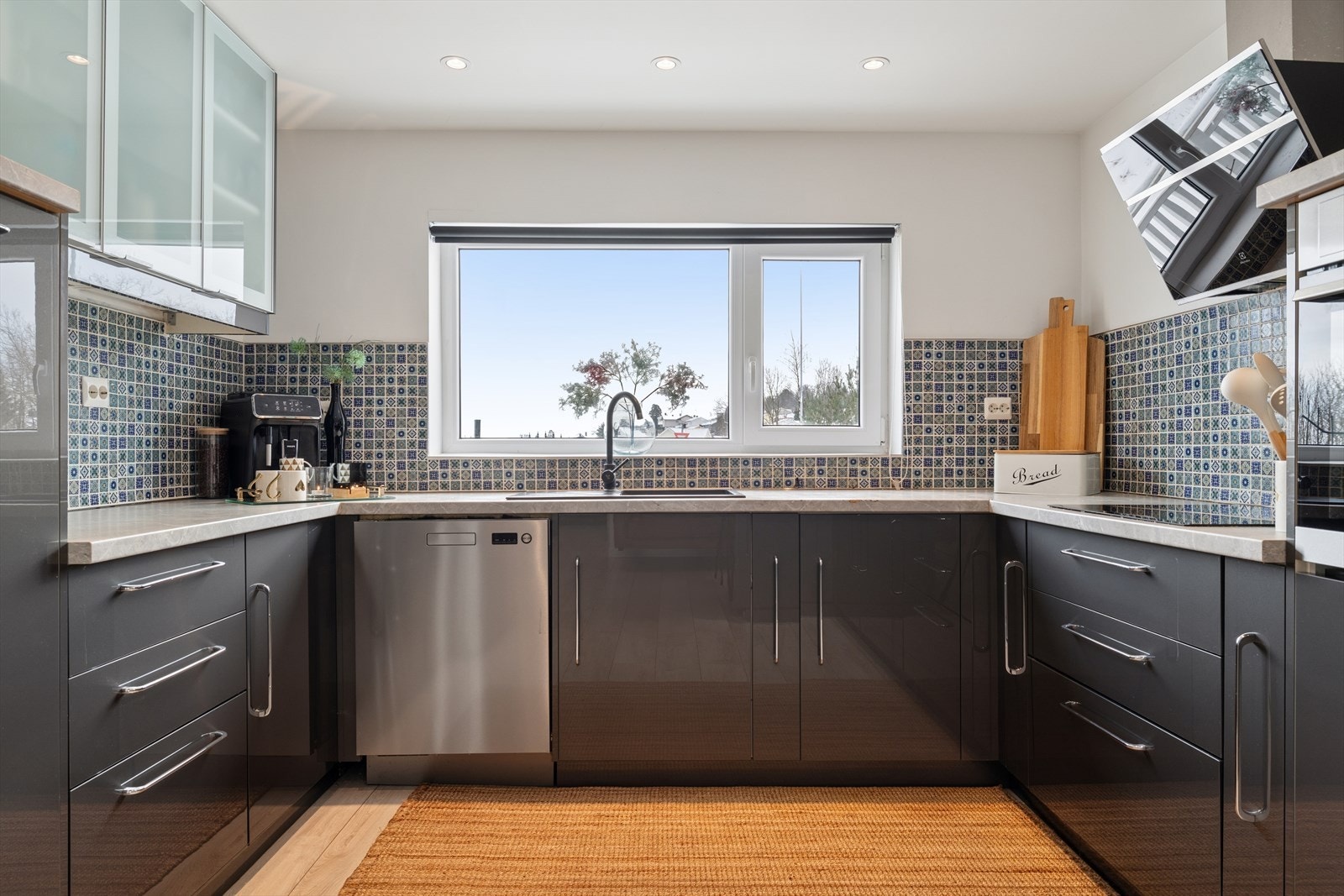 Det er lagt fliser på deler av veggen mellom over- og underskap. Galleribilde