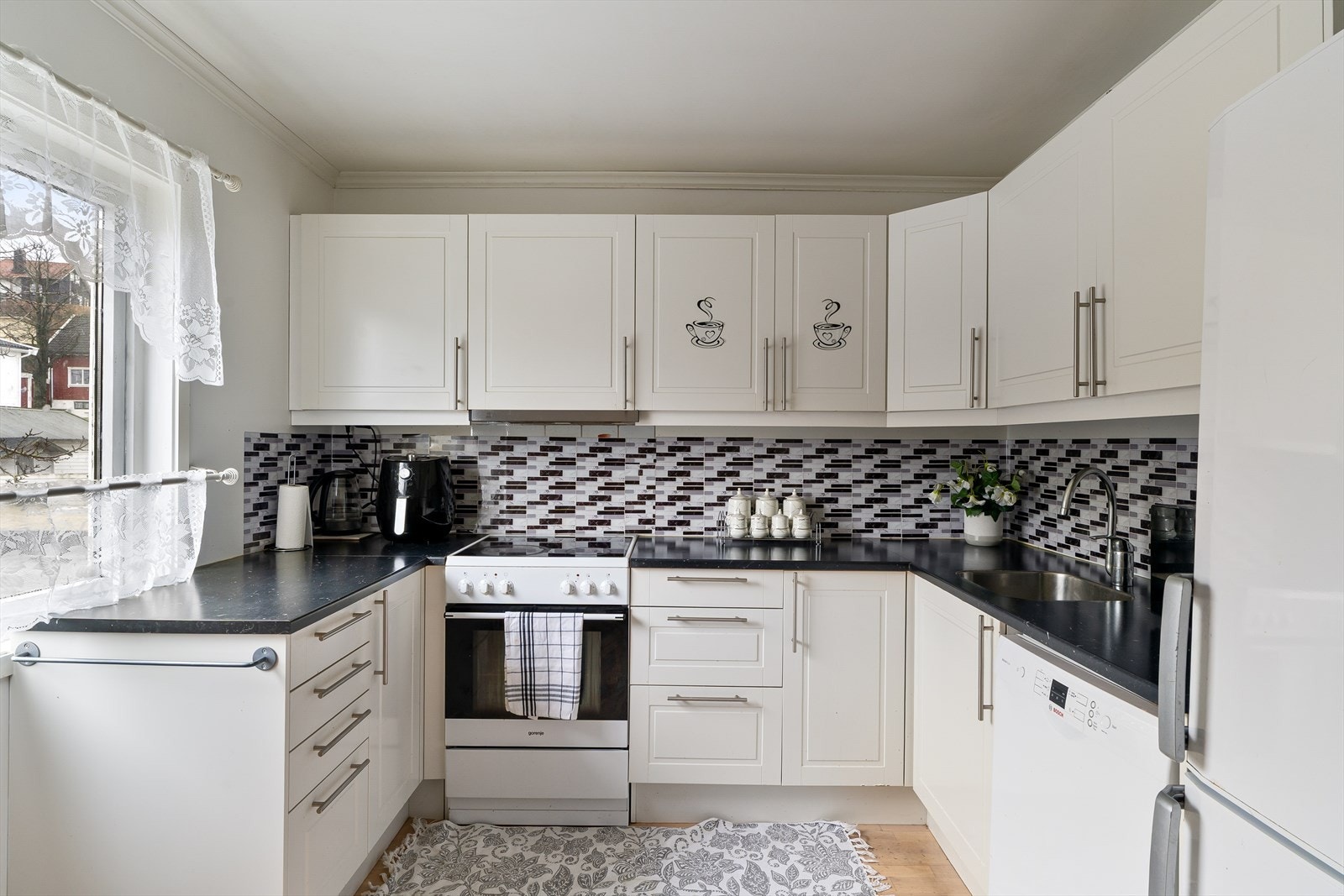 Kjøkken med slette fronter, og rikelig med skap- og benkeplass Galleribilde