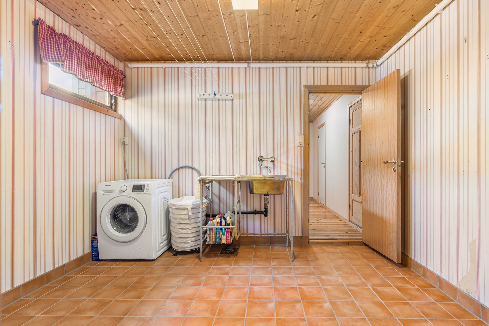 Romslig vaskerom på 10 m², flislagt gulv med gulvvarmer og opplegg for vaskemaskin, utslagsvask og varmtvannsbereder. Galleribilde