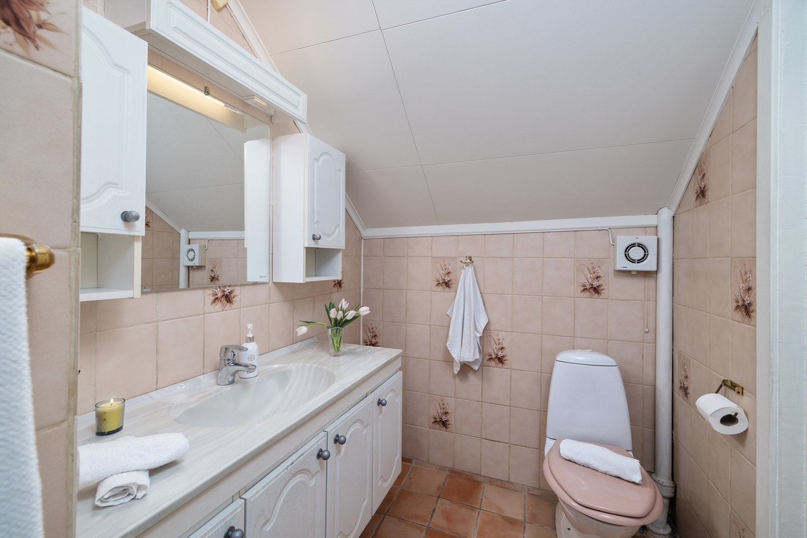 Badet har flislagte overflater og servantinnredning med god oppbevaring. Galleribilde