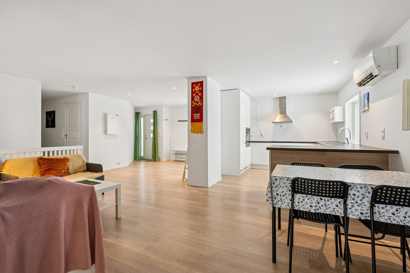 Den åpne løsningen mellom stue og kjøkken skaper en sosial og innbydende atmosfære. Galleribilde