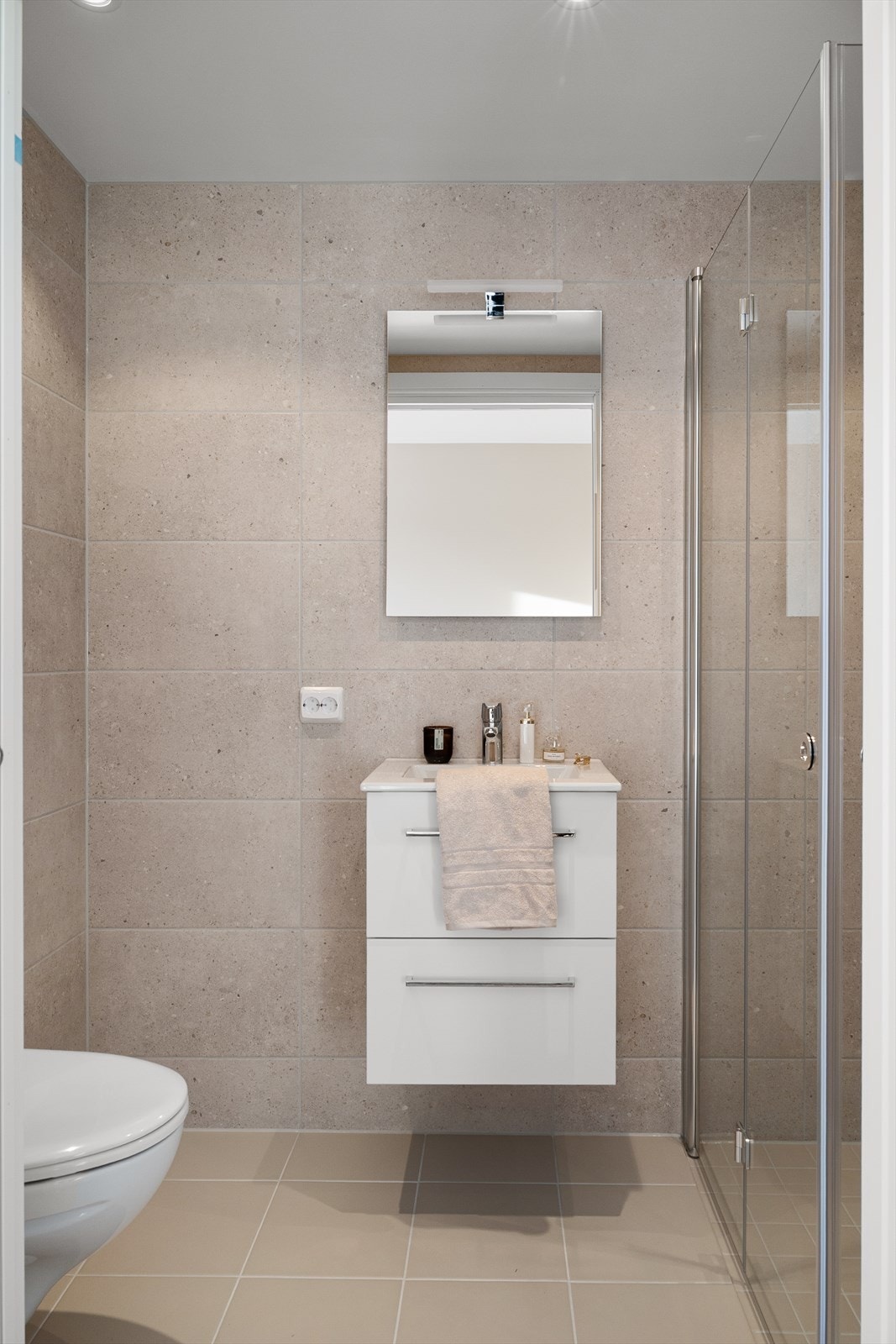 Stilrent, helfliset bad med vegghengt innredning og integrert speilbelysning. Galleribilde