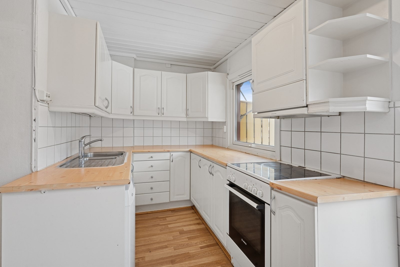 Innredningen har hvite, profilerte fronter, laminat benkeplate og godt med lagringsplass. Galleribilde