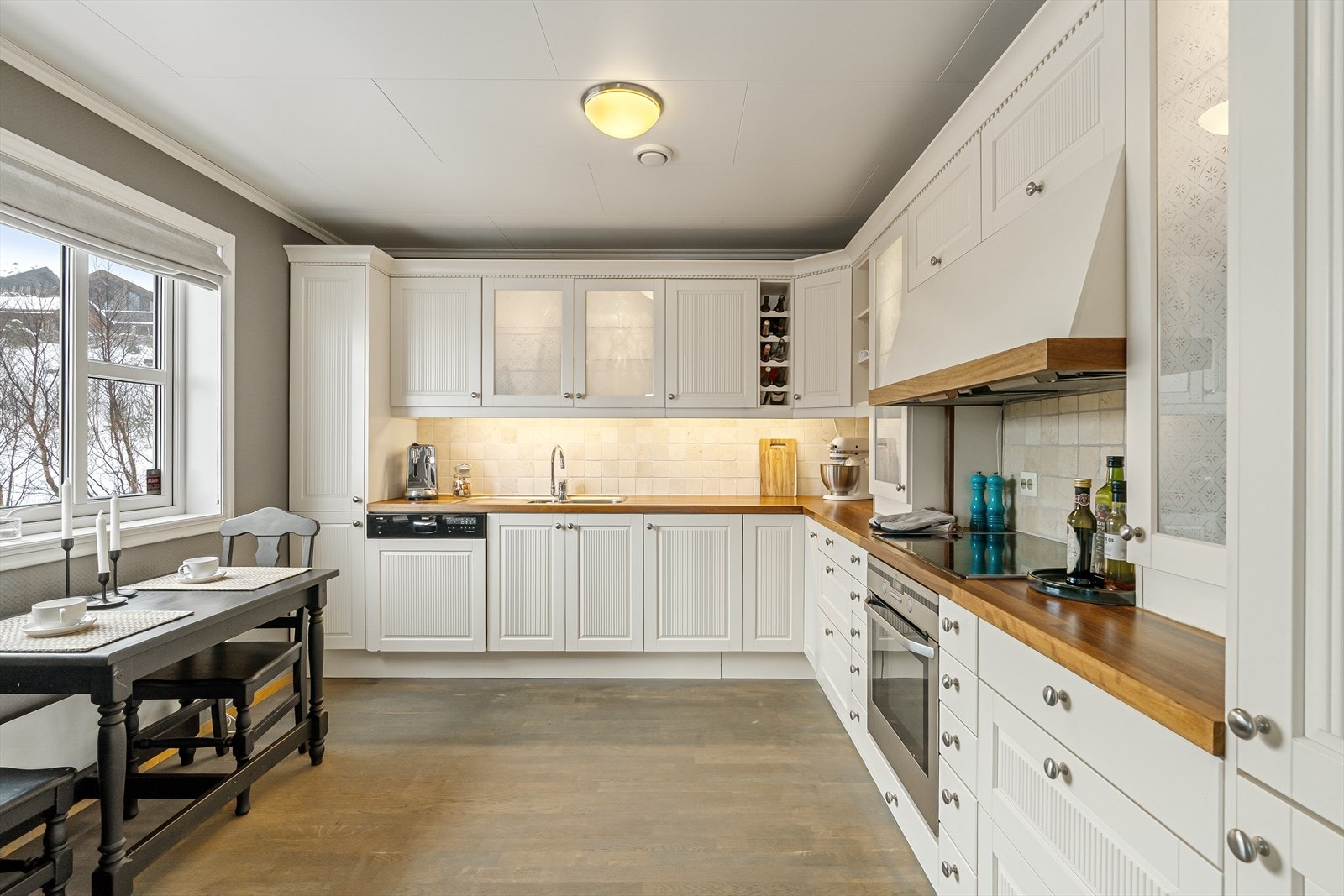 Pent, lyst kjøkken med integrerte hvitevarer Galleribilde