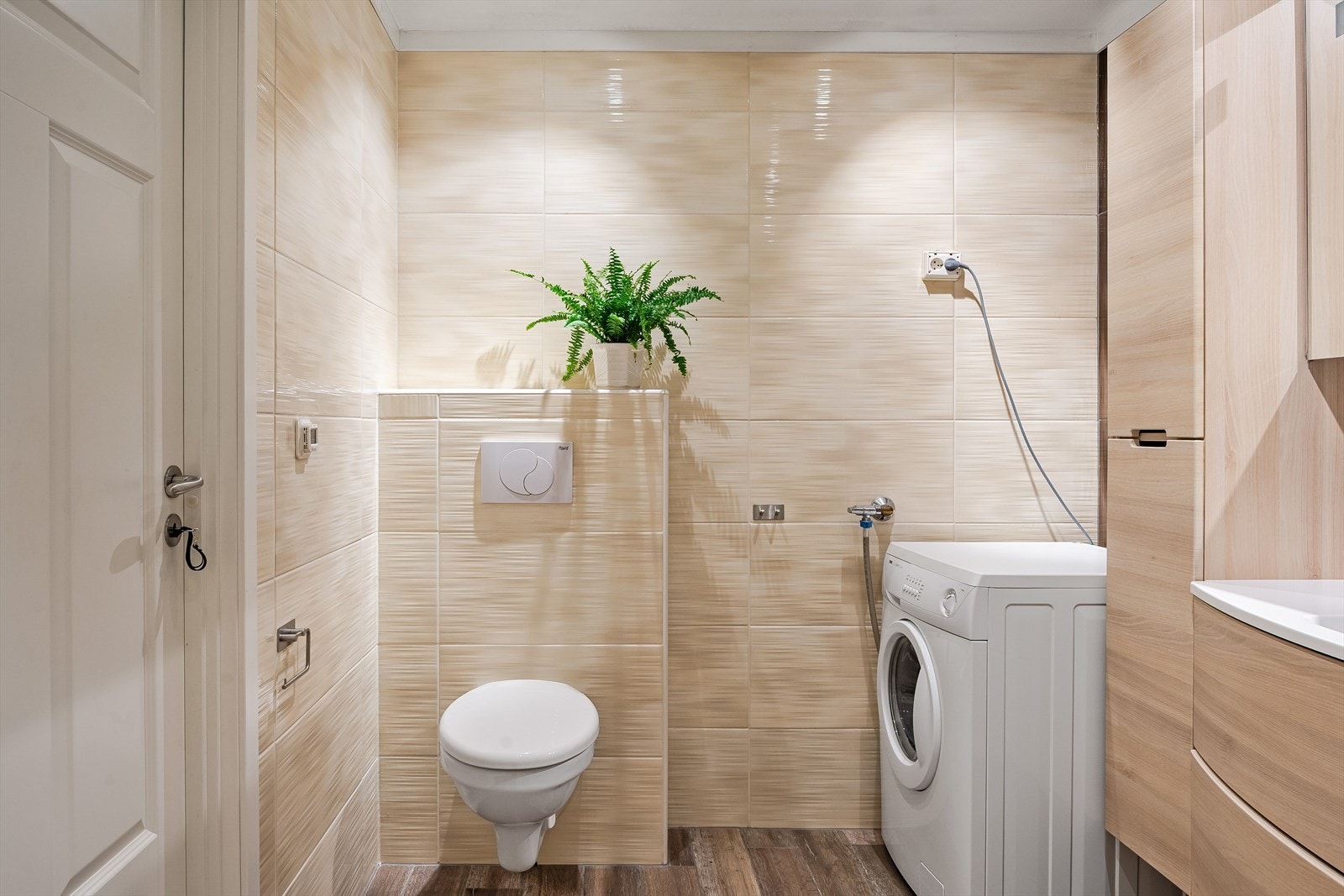 I hjørnet er det plass og opplegg for vaskemaskin og tørketrommel over om ønskelig. Baderommet har fliser på gulv og vegger, elektrisk gulvvarme, downlights i himlingen og mekanisk avtrekk. Galleribilde