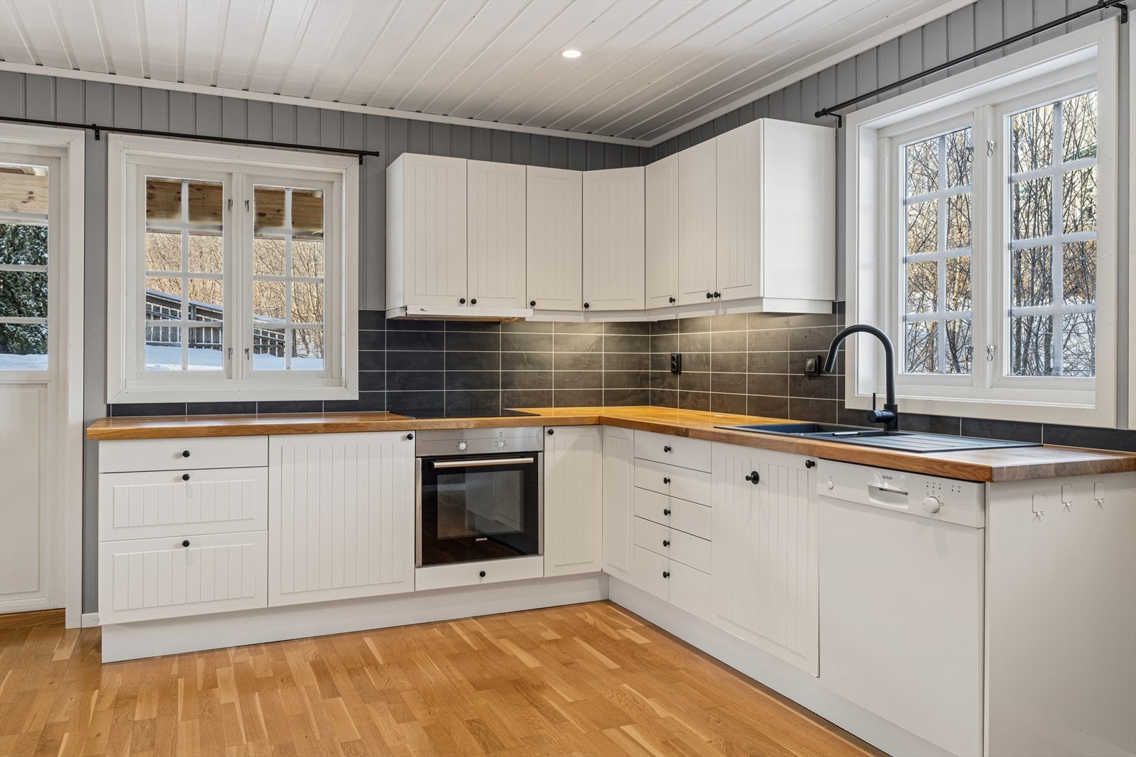 Kjøkkenet er utstyrt med hvite fronter, god benkeplass og moderne integrerte hvitevarer. Galleribilde