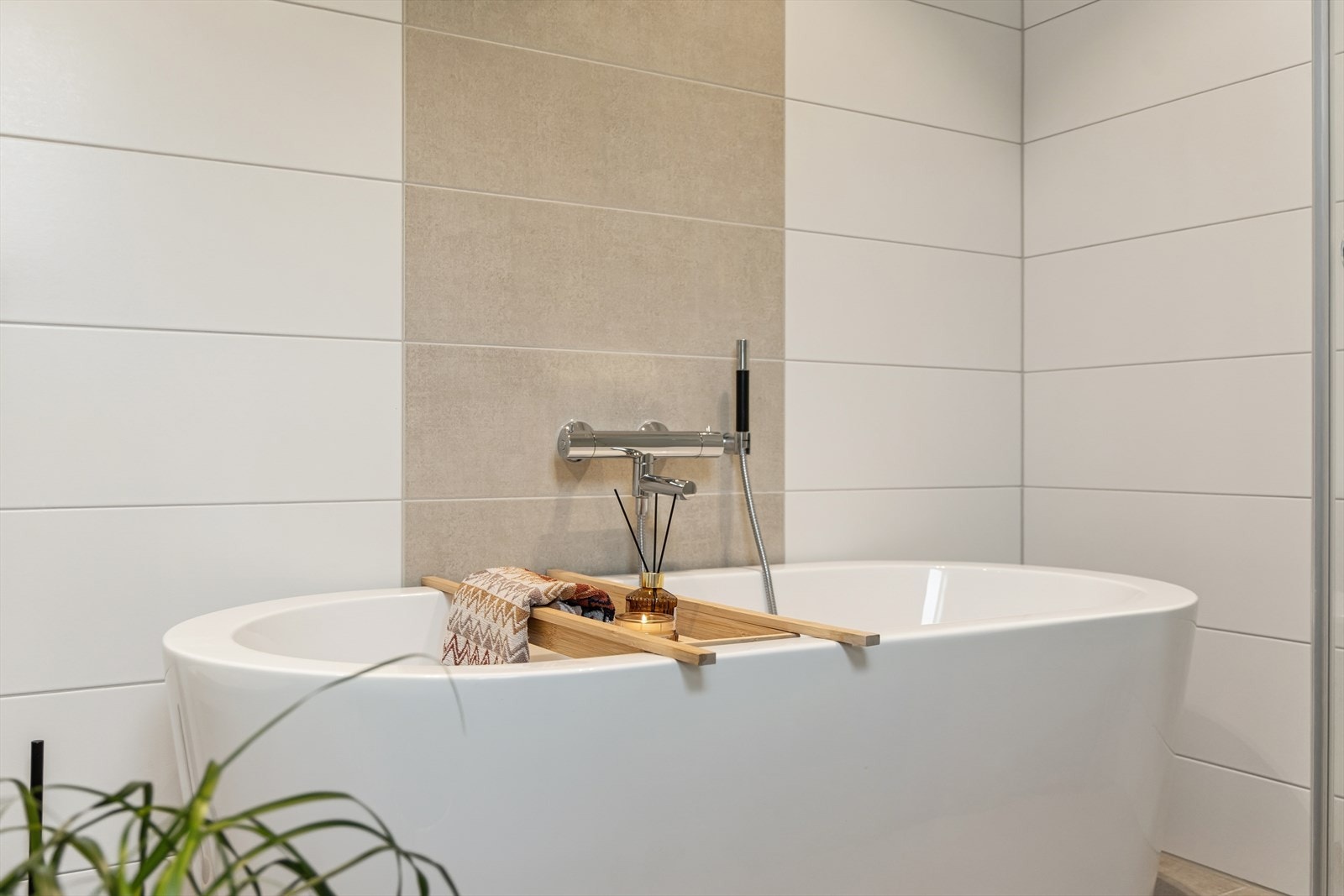 Badet er ellers utstyrt med dusjhjørne, badekar, vegghengt toalett og baderomsinnredning med god lagringsplass og nedfelt servant. Galleribilde