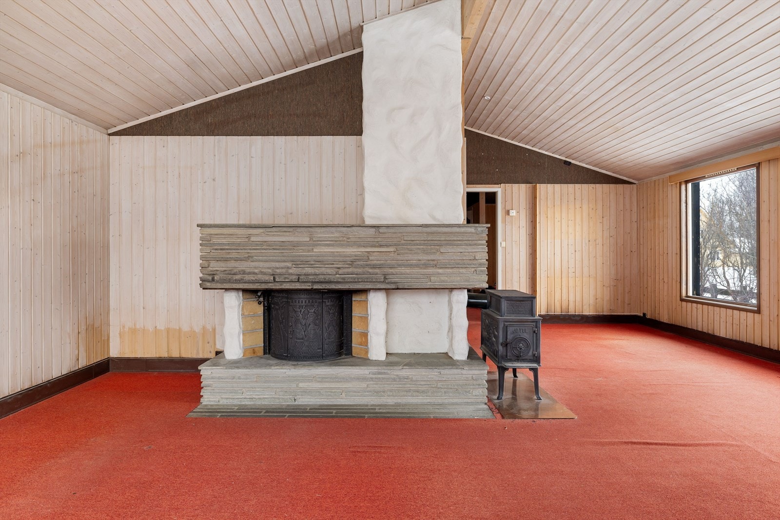 Stue med peis og vedovn, samt varmelister. Galleribilde