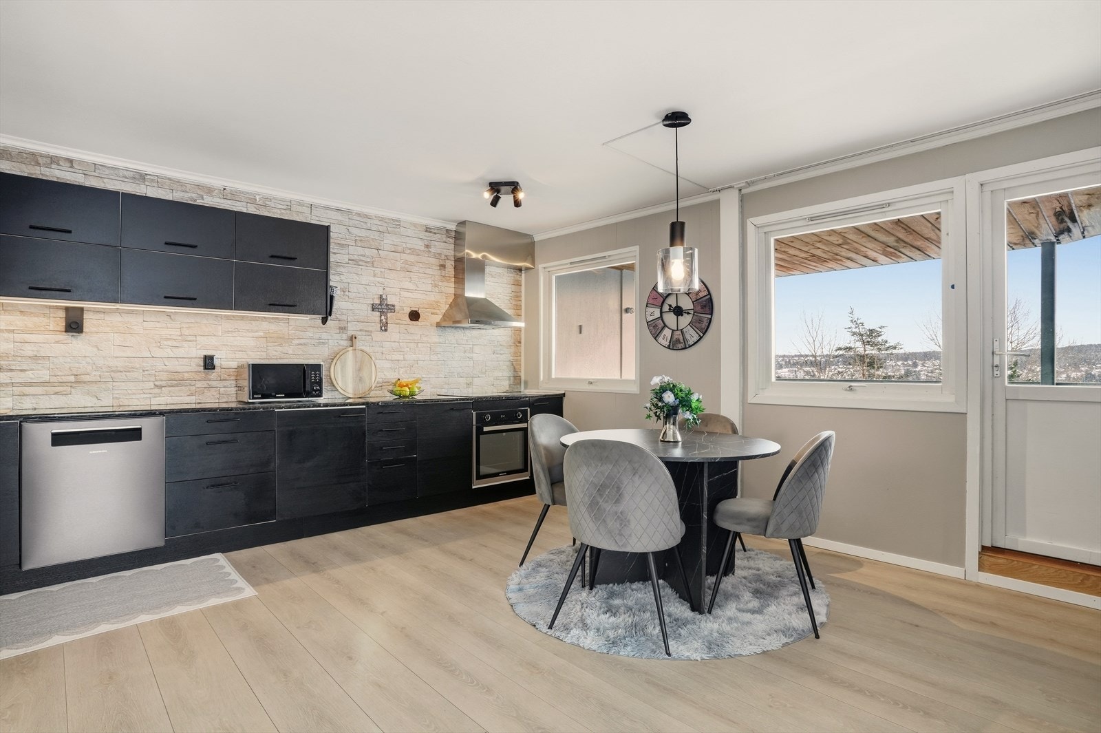 Moderne kjøkkeninnredning i slette, mørke fronter og mørk benkeplate i laminat Galleribilde