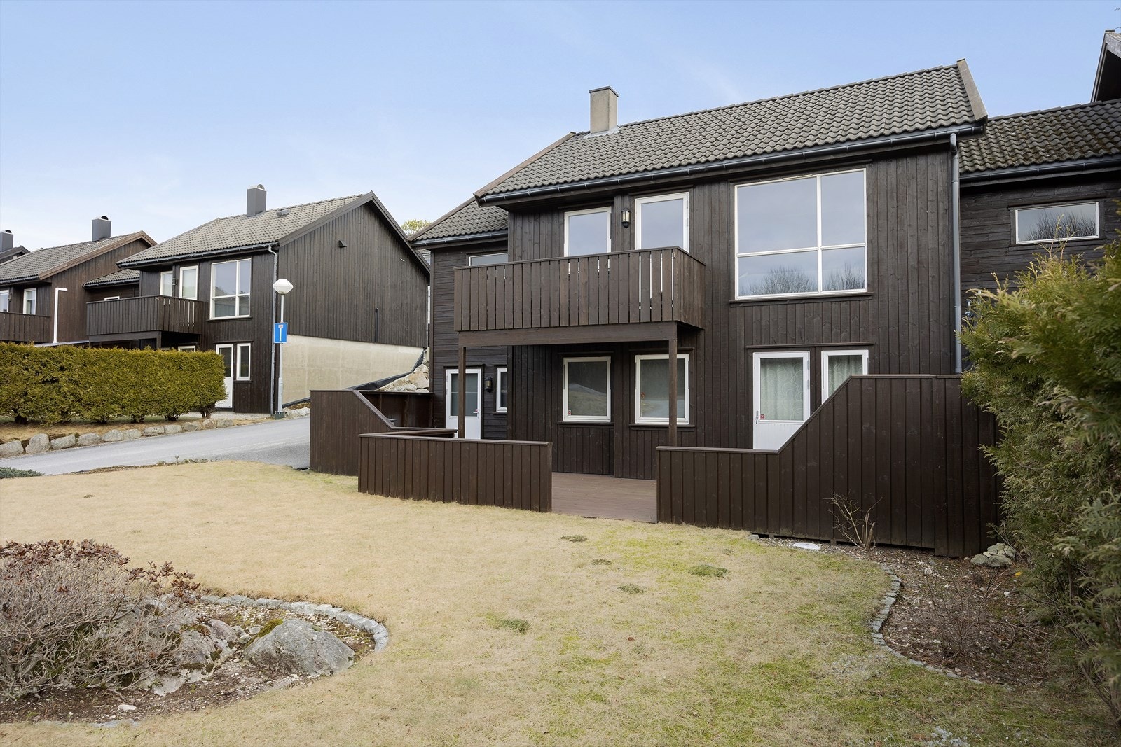 Endetomt som er opparbeidet med hage, fin terrasse, noe beplantning og asfaltert gårdsrom. Galleribilde