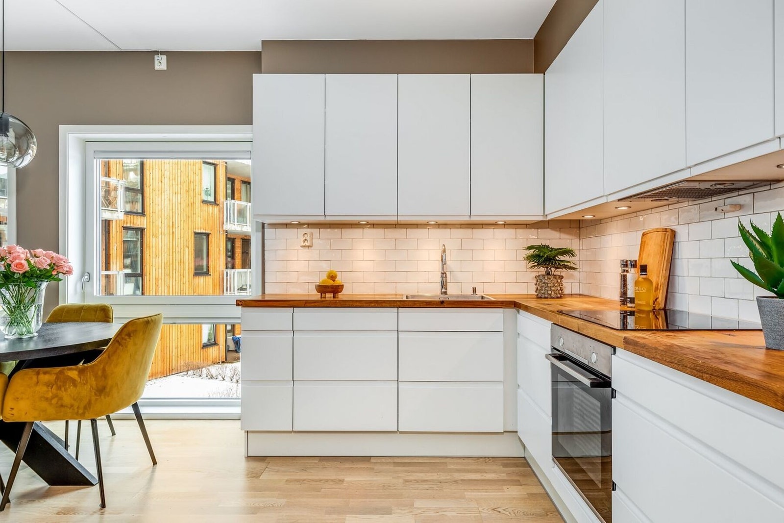 Kjøkkenet er utstyrt med ventilator over stekesone, med avtrekksløsning via byggets balanserte ventilasjonssystem. Legg merke til den gjennomtenkte belysningsløsningen med integrerte downlights under overskapene. Galleribilde