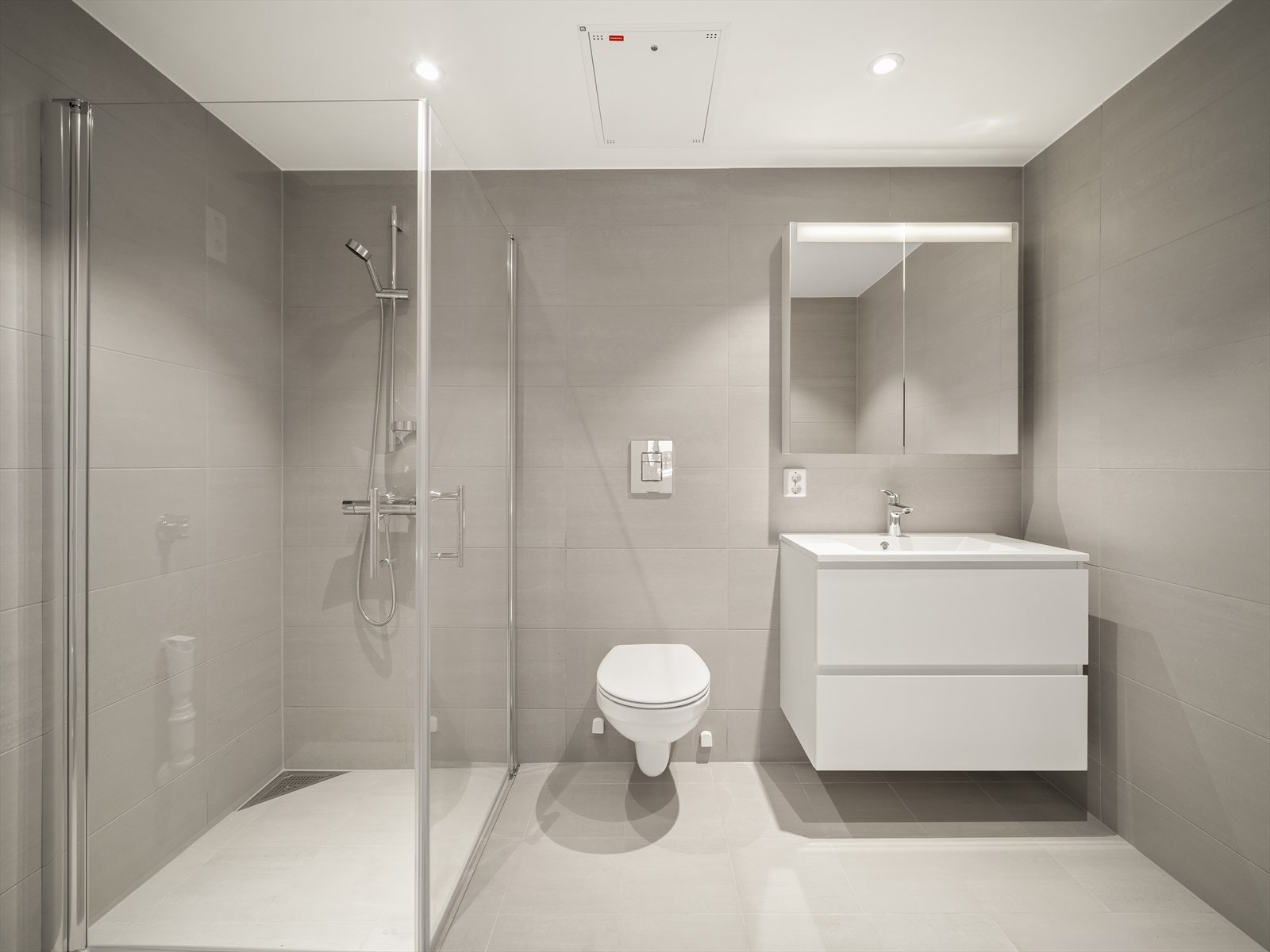 Delikat flislagt baderom med opplegg for vaskemaskin. Downlights i himling. Galleribilde