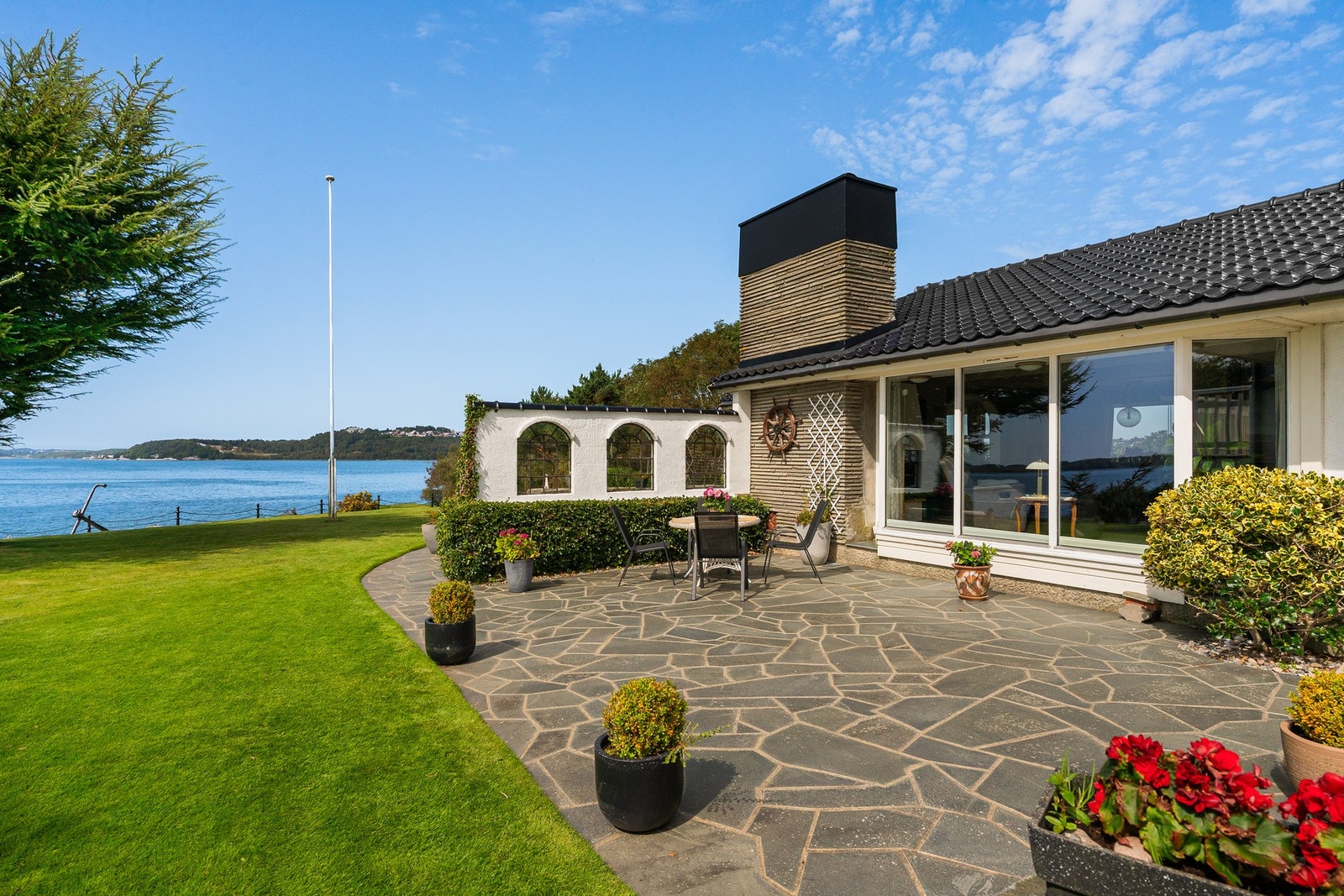 Flott skiferbelagt uteområde som egner seg godt for uteservering, grillkvelder eller rolige stunder i solen. Galleribilde