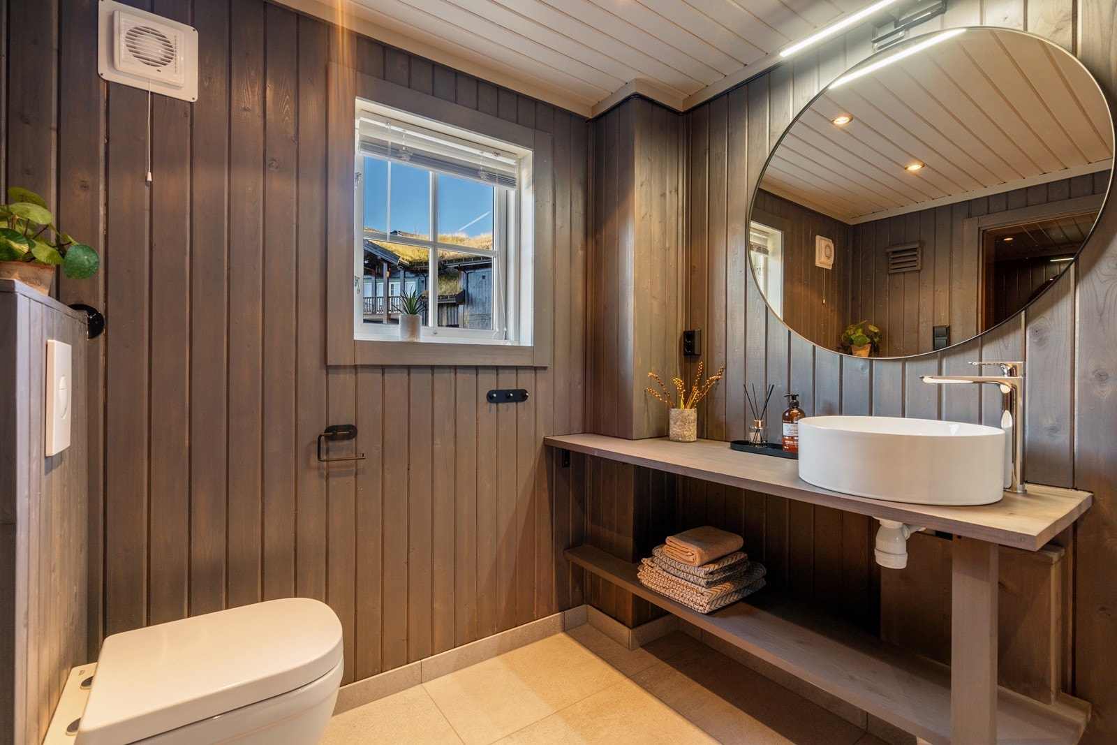 Gulvet er flislagt med nedsenket gulv i dusj. Rommet har elektriske varmekabler. Nyere stålsluk og smøremembran med dokumentert utførelse. Veggene har fliser i dusj og panel på resten. Taket har panel. Det er elektrisk styrt vifte. Galleribilde