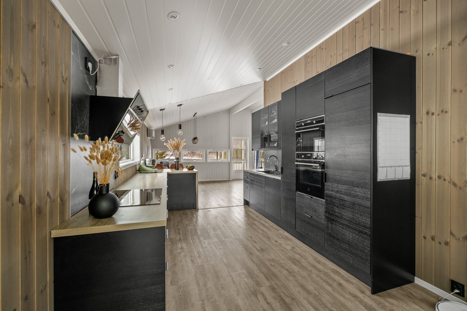 Innredning med integrert oppvaskmaskin, komfyr, kjøleskap og platetopp. Galleribilde