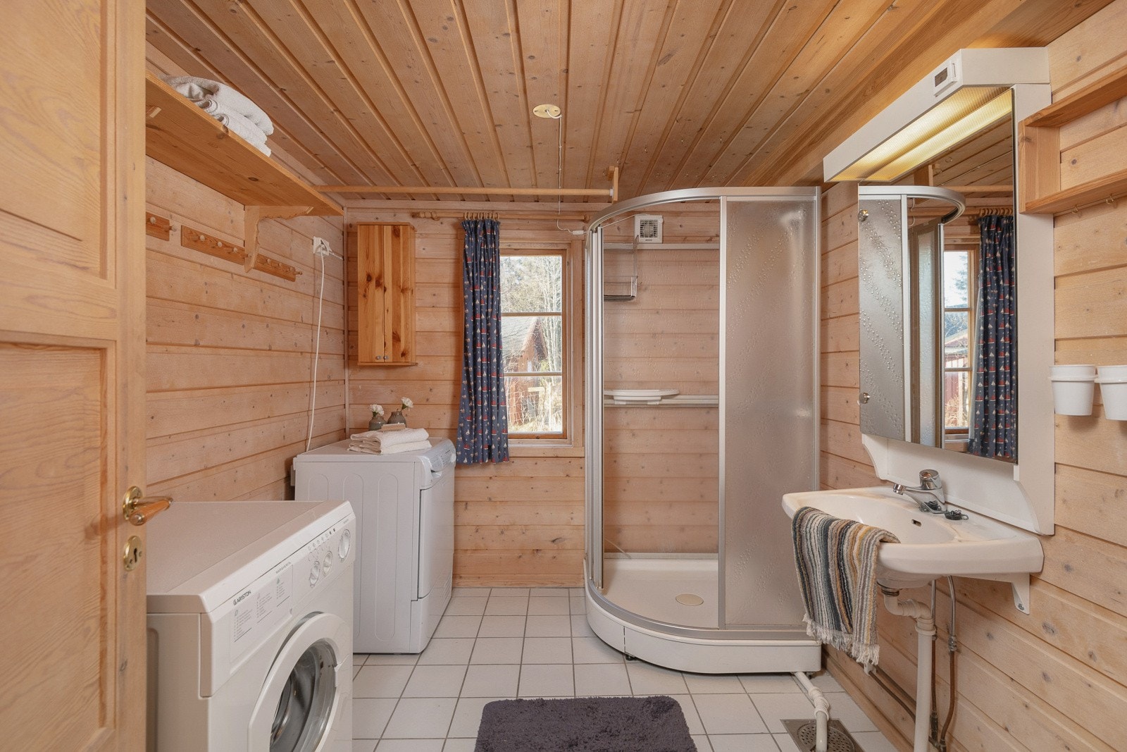 Badet i 1. etasje har panel på veggene og fliser på gulvet med behagelige varmekabler. Galleribilde