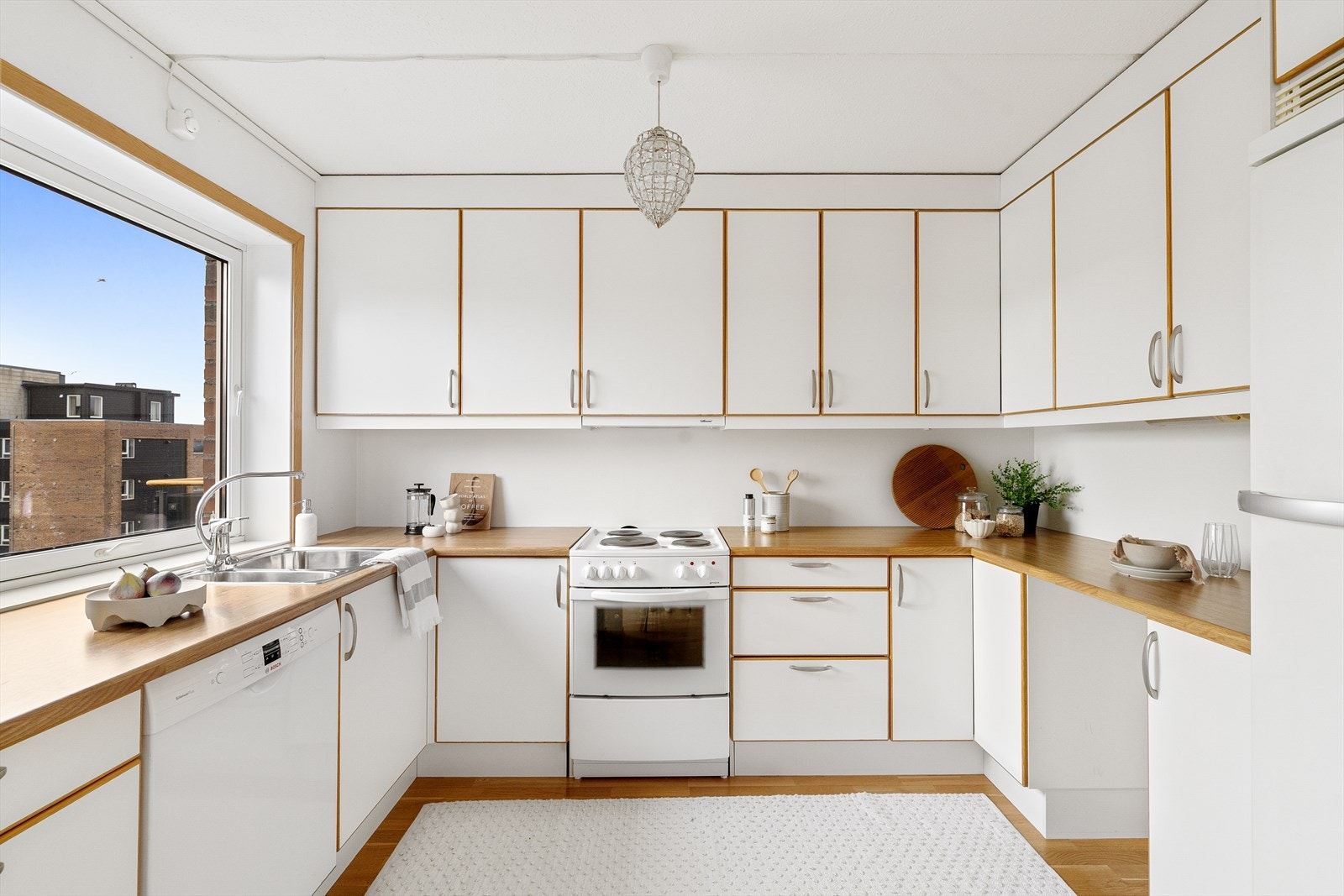 Kjøkken med hvite fronter og parkett på gulv Galleribilde