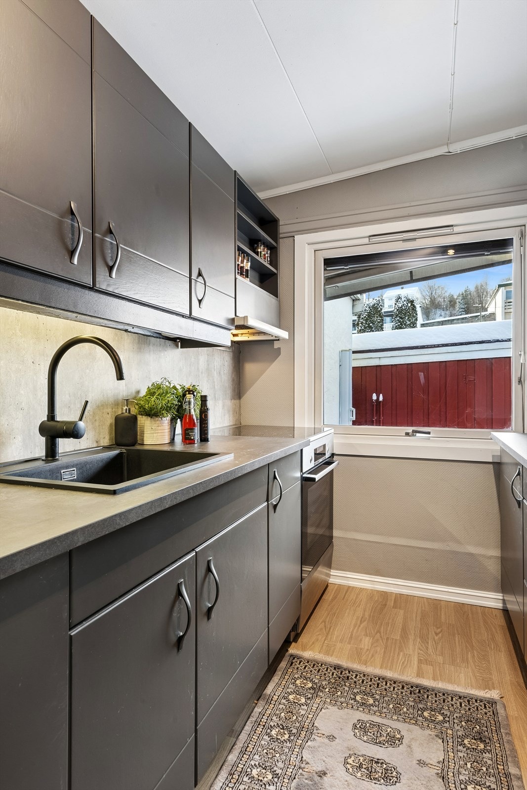 Kjøkkeninnredning med glatte fronter og slitesterk laminatbenkeplate. Galleribilde