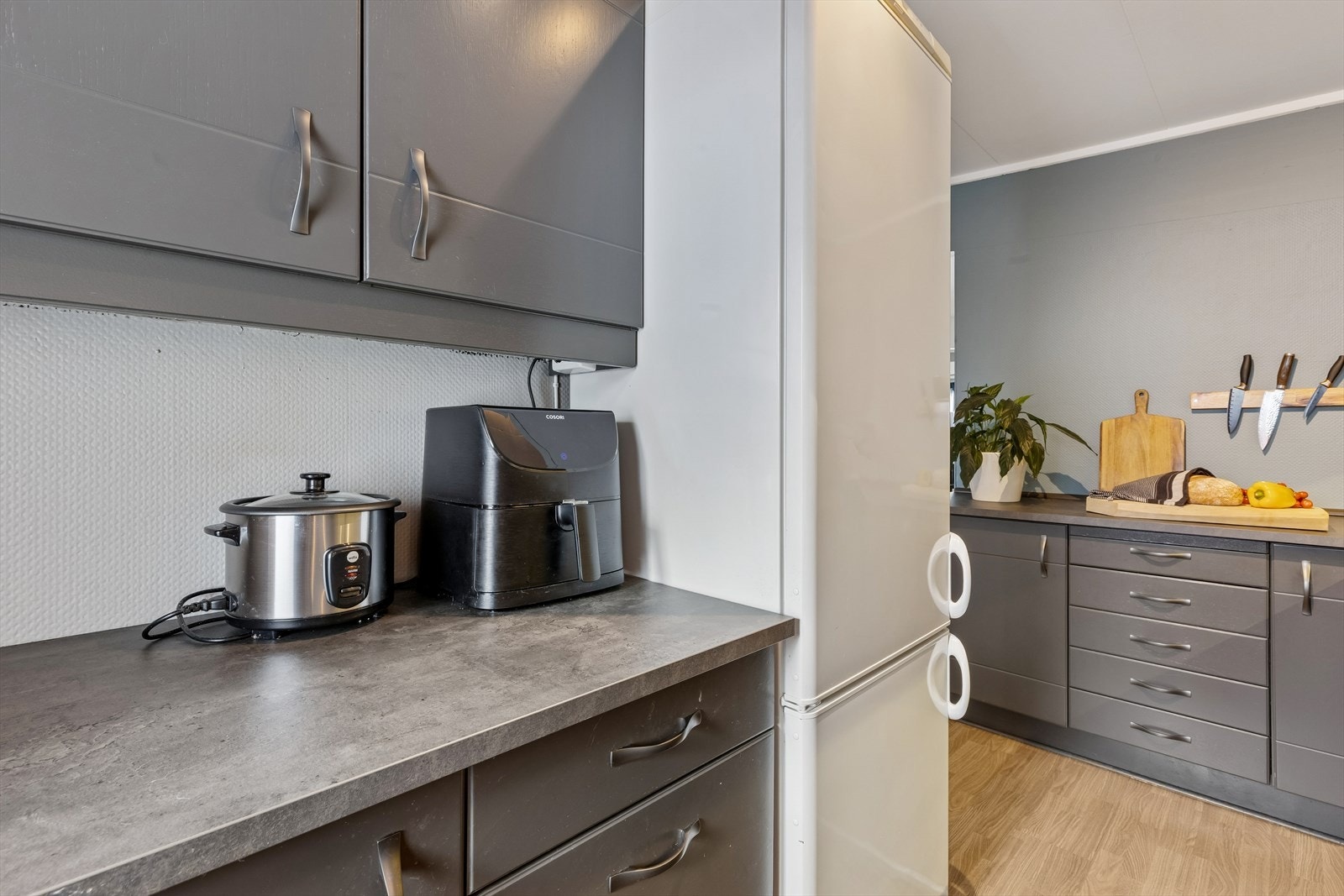 Rommet er utstyrt med integrert oppvaskmaskin og frittstående kjøl- og fryseskap. Galleribilde