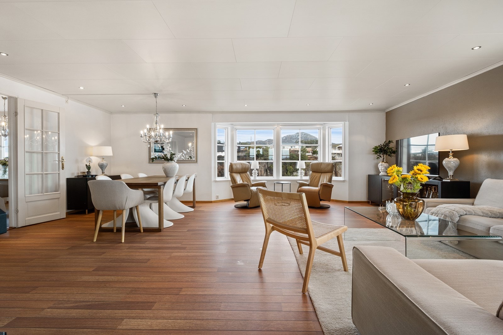 Stuen er lys og luftig med spotlights i taket og god plass til stort spisebord og sofagruppe. Galleribilde