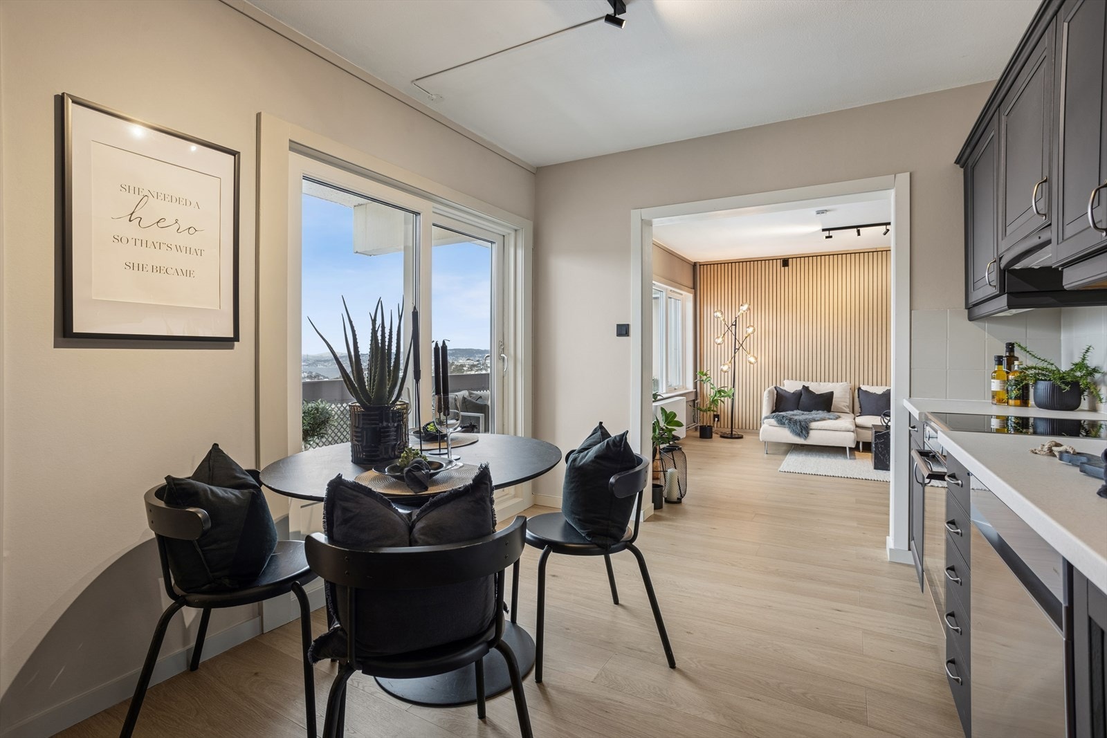 Oversiktlig kjøkken med inngang til stuen og tilgang til veranda. Galleribilde